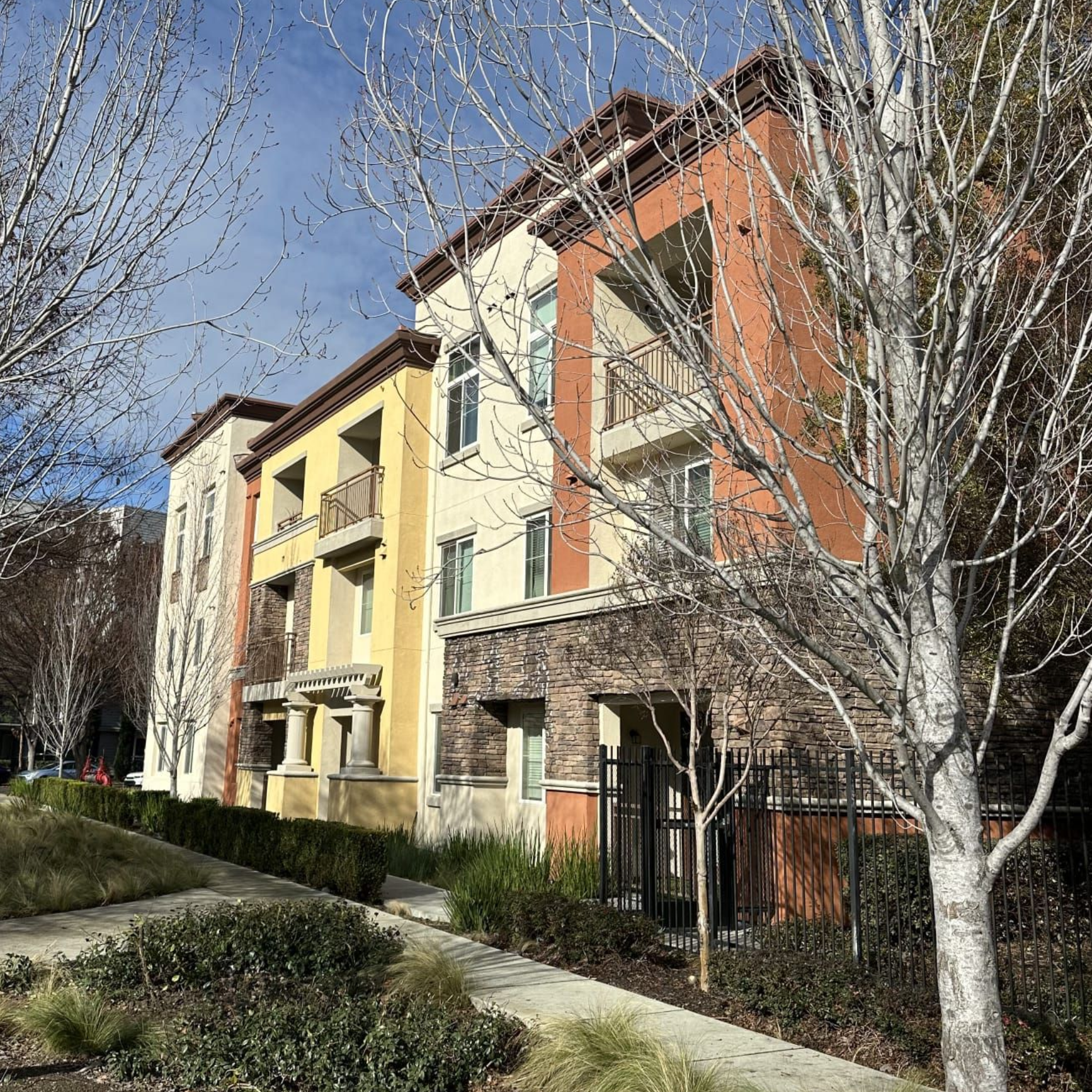 Exterior view featuring a two-tone stucco and stone veneer 