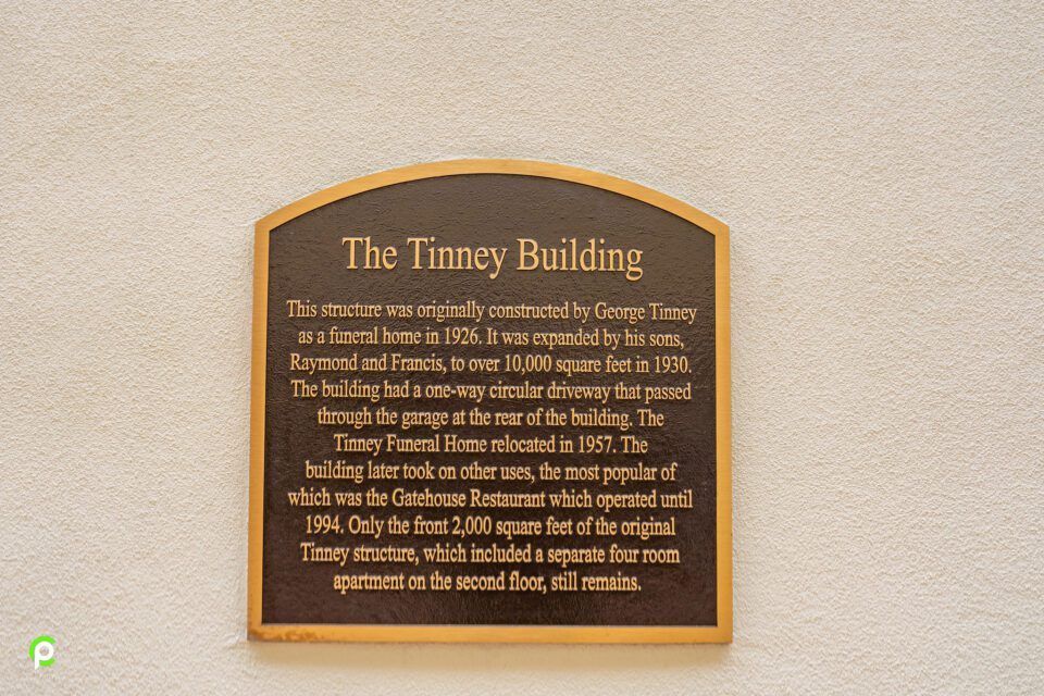 A plaque on a wall that says the timey building