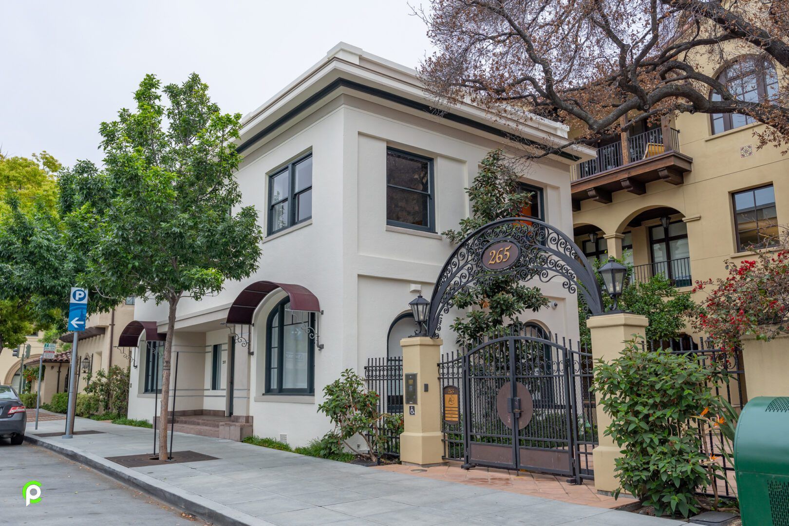 A large white building with a gate in front of it