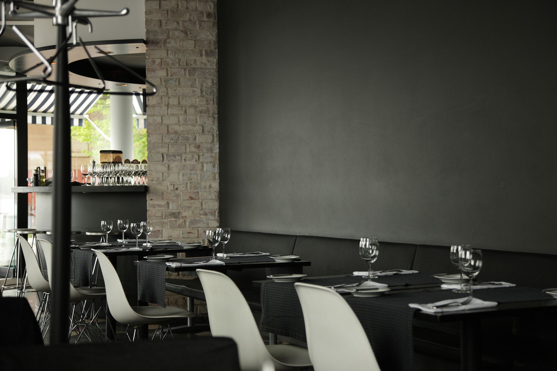 A restaurant with black tables and white chairs