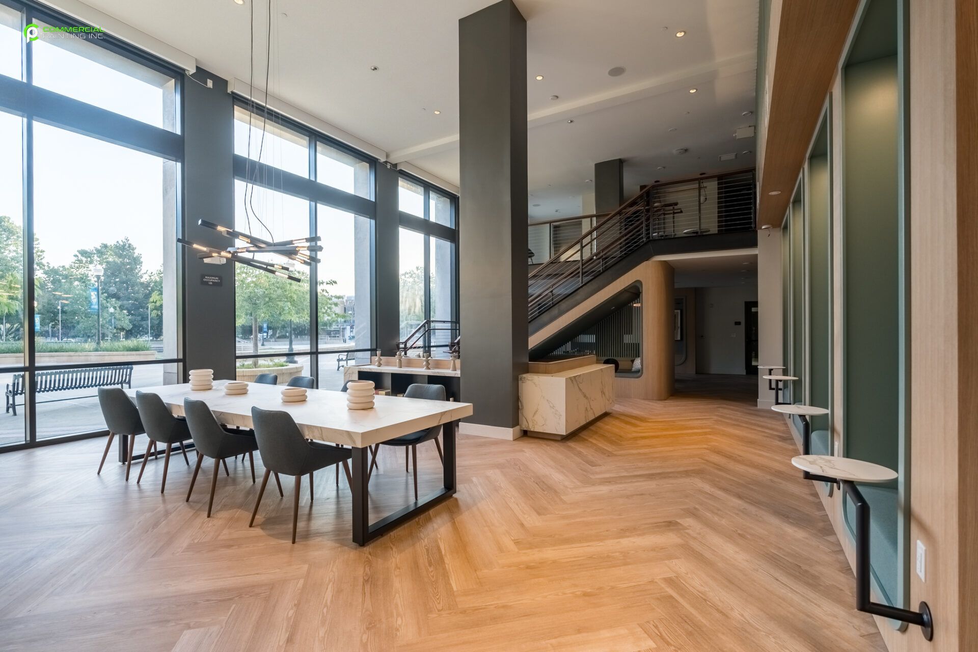 A large room with a table and chairs in it.