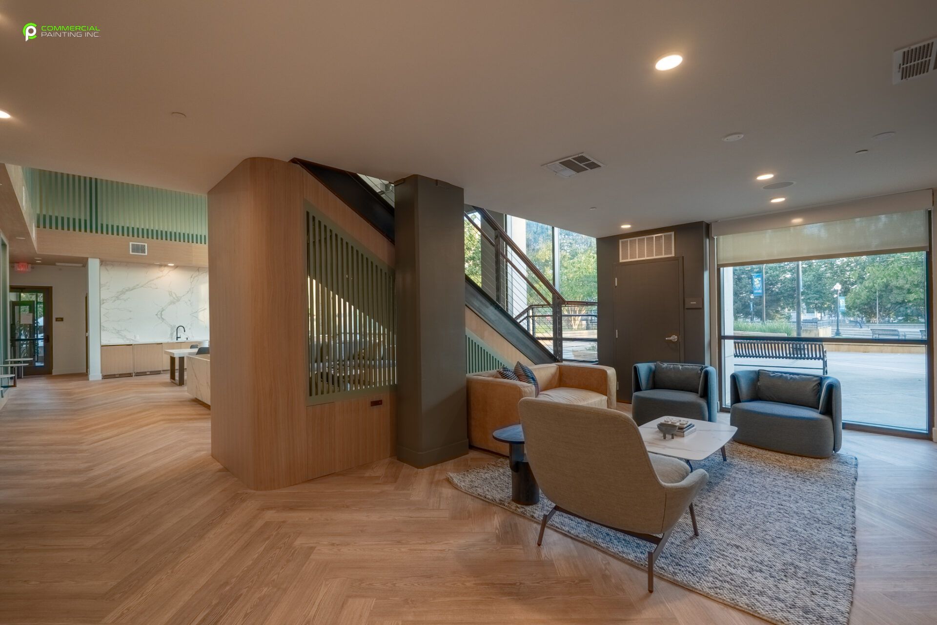 A living room with a lot of furniture and a staircase.