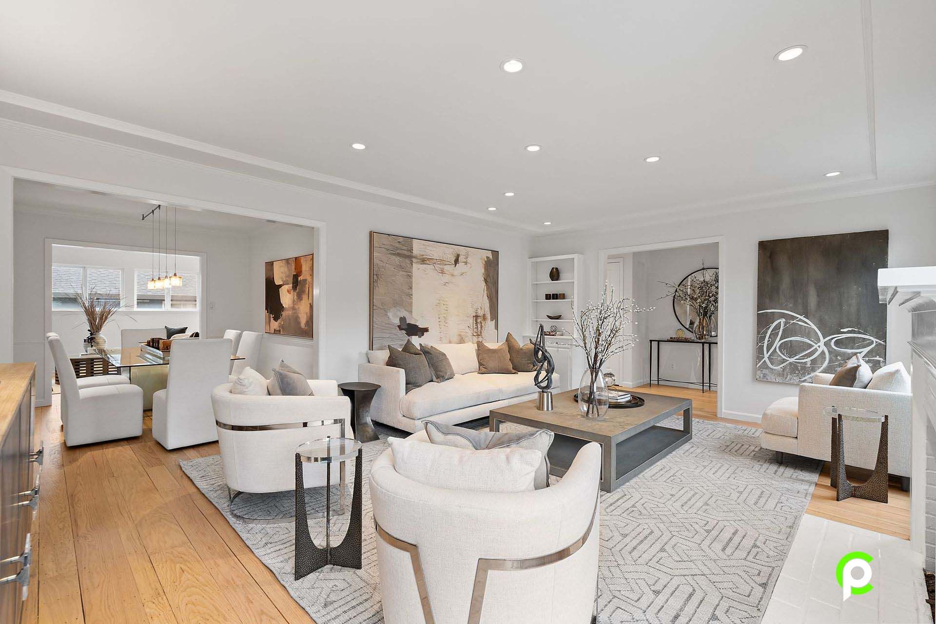 A living room with a couch , chairs , and a coffee table.