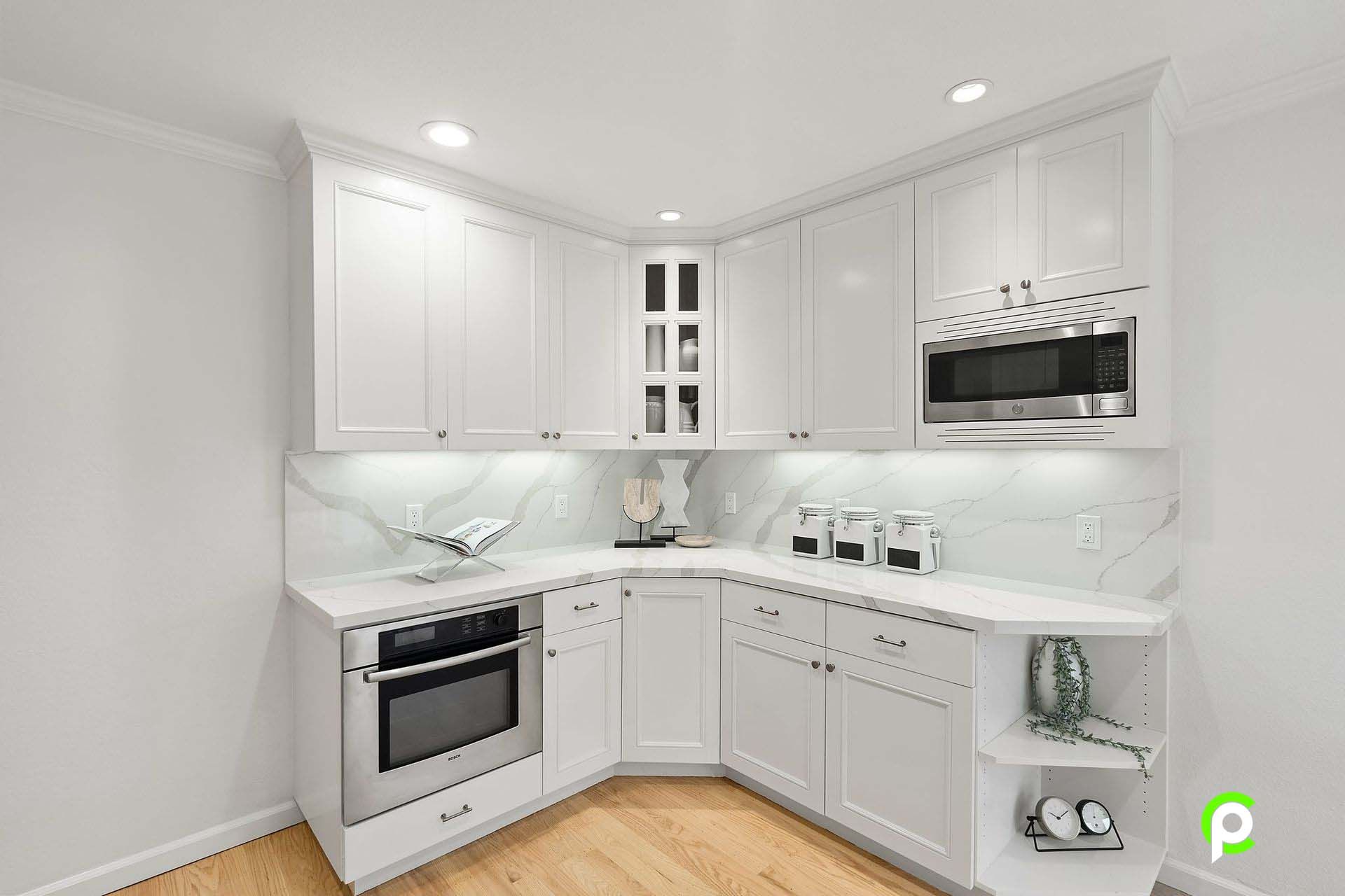 A kitchen with white cabinets and stainless steel appliances.