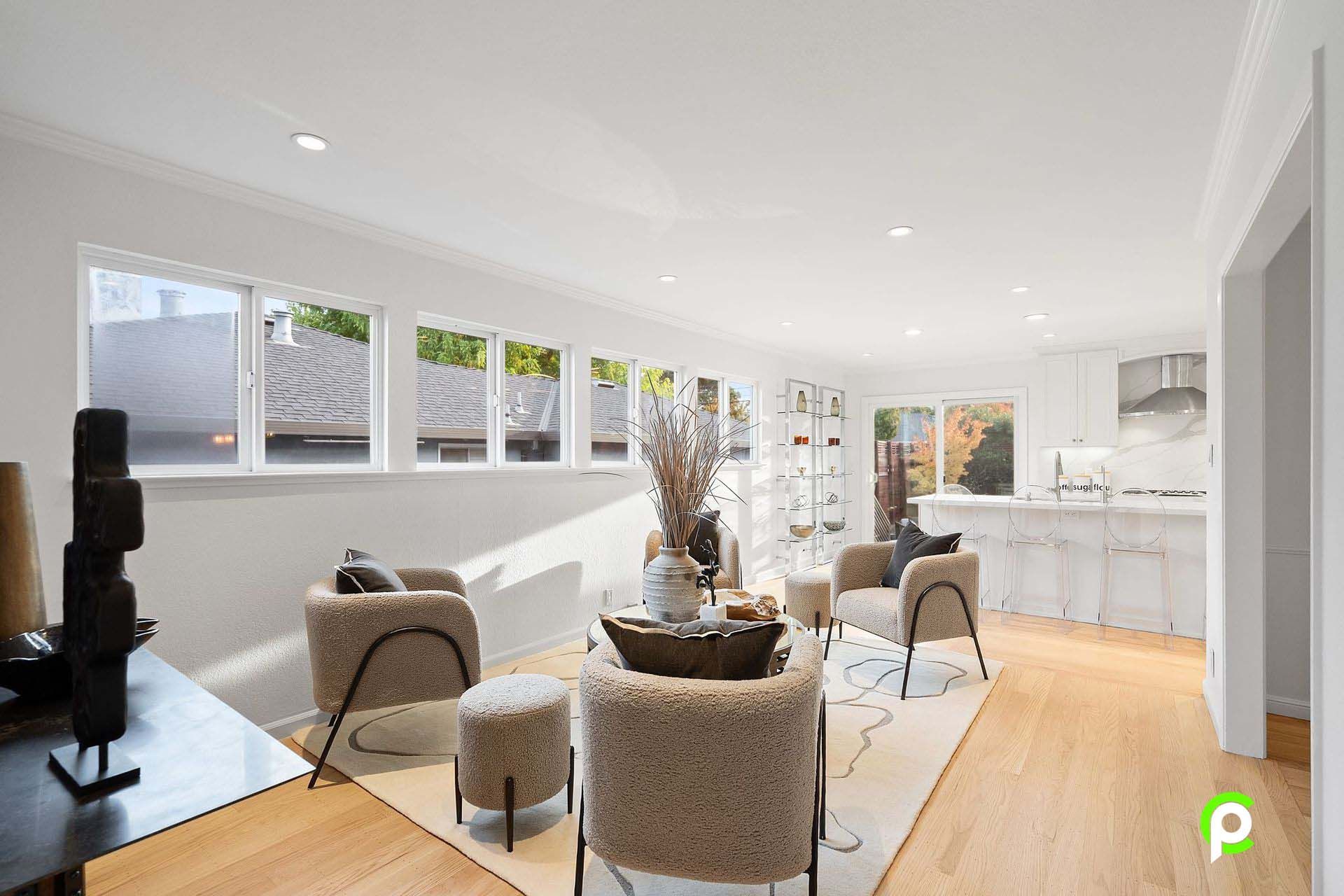 A living room filled with furniture and a lot of windows.