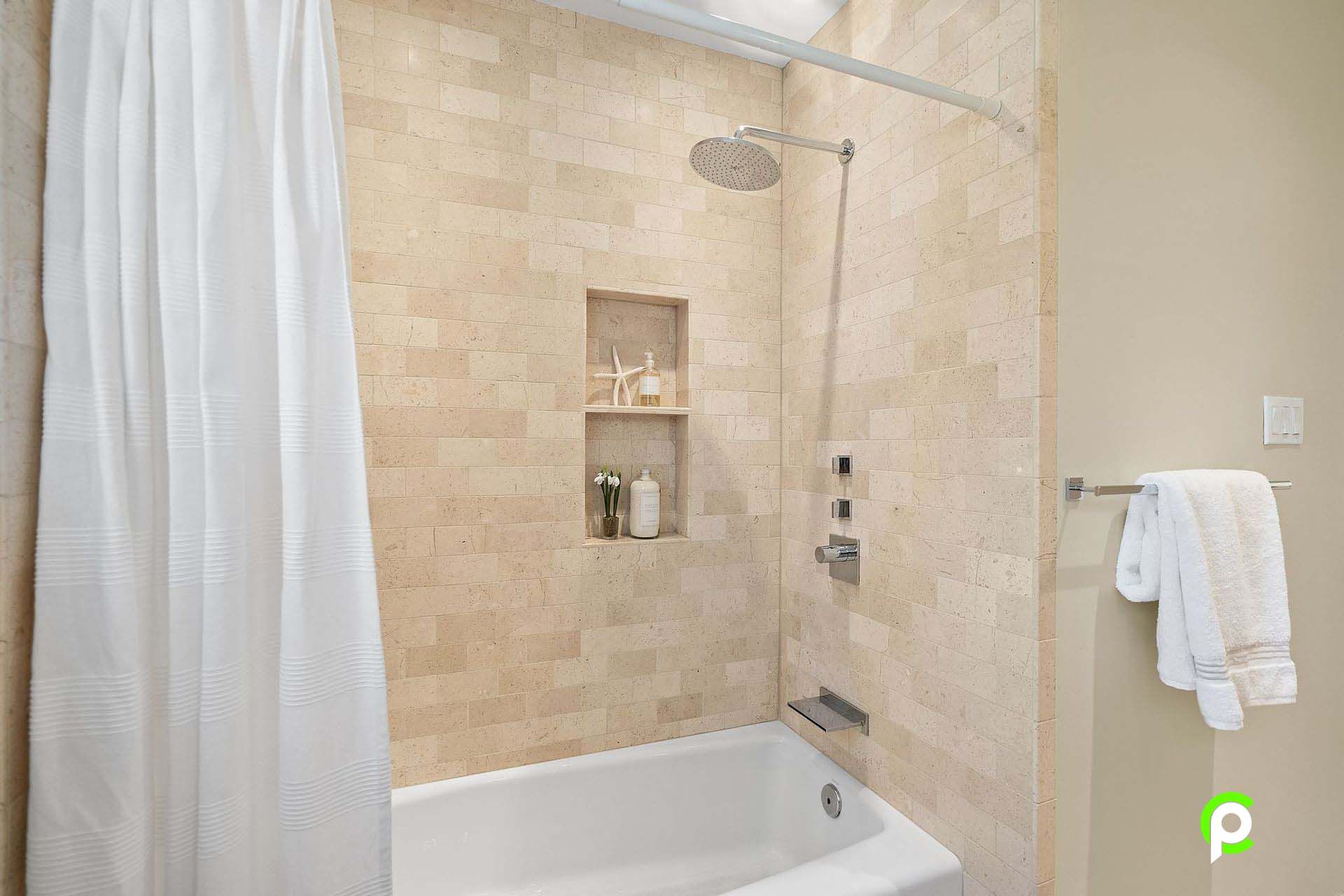 A bathroom with a bathtub and a shower with a shower curtain.
