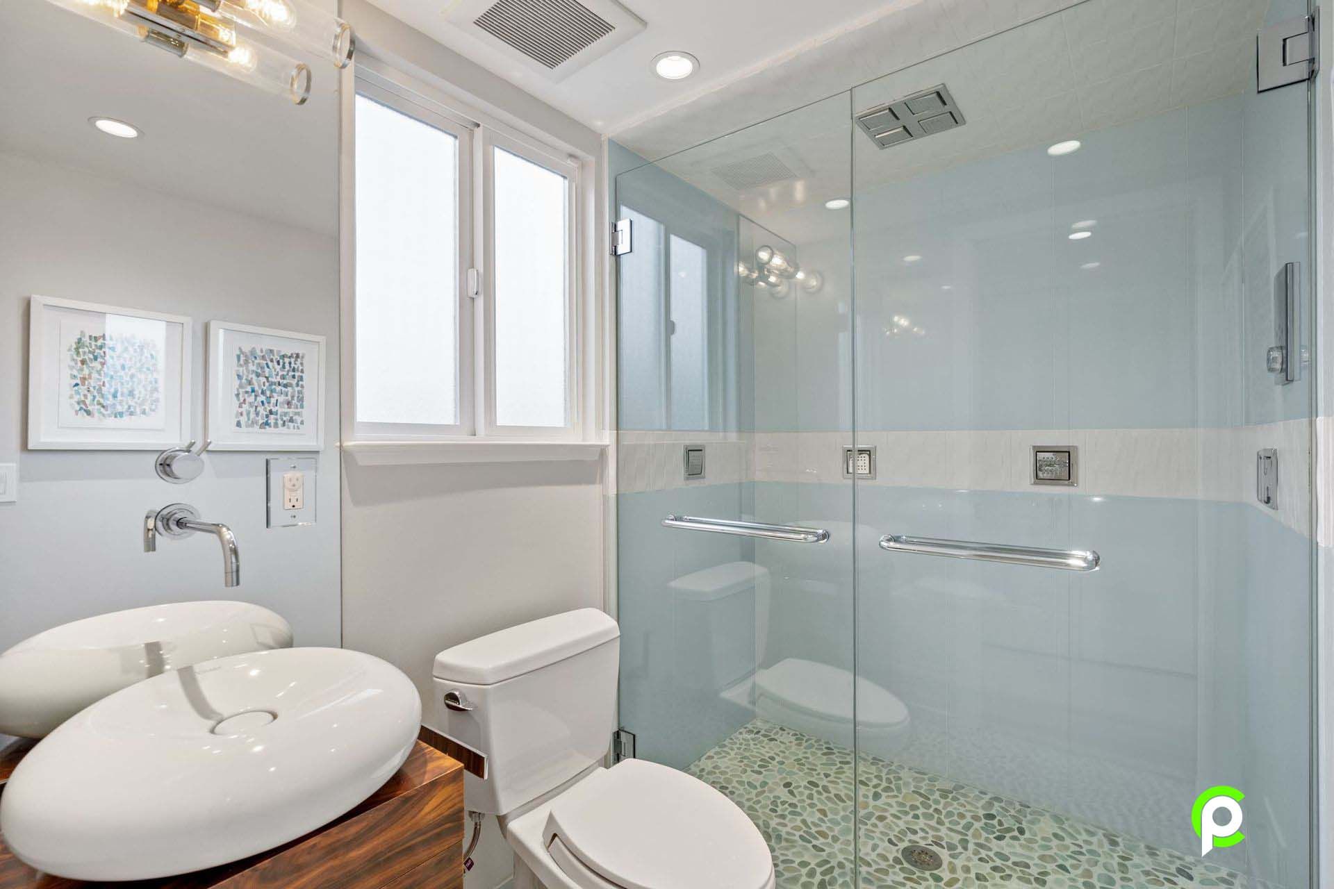 A bathroom with a toilet , sink , and shower.