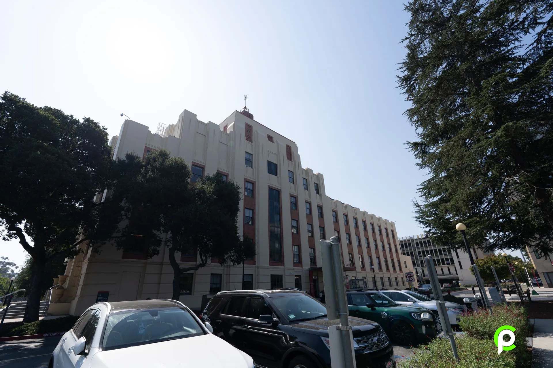 A large building with cars parked in front of it