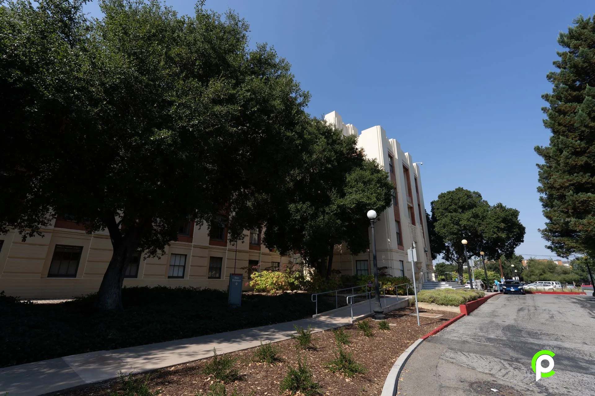 A large building with a lot of trees in front of it