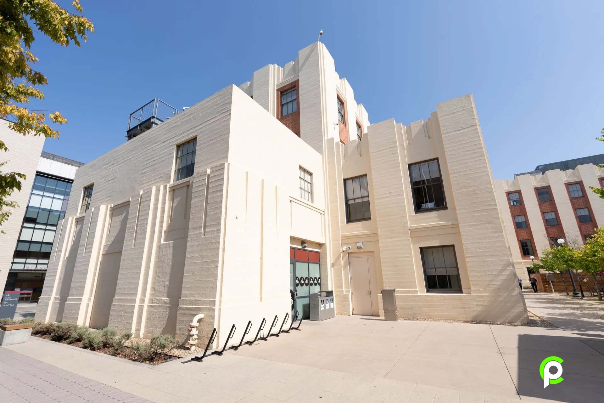 A large white building with a blue sky in the background