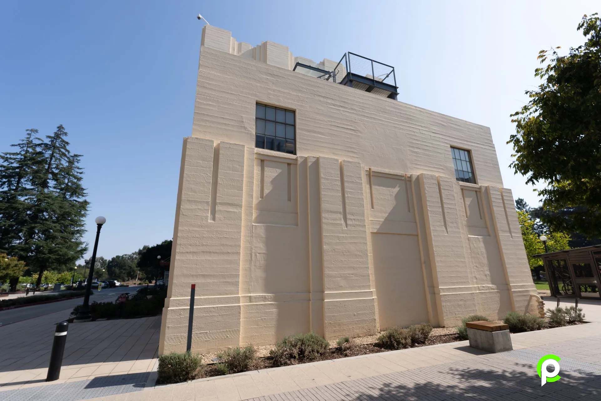 A large white building with a lot of windows and a roof