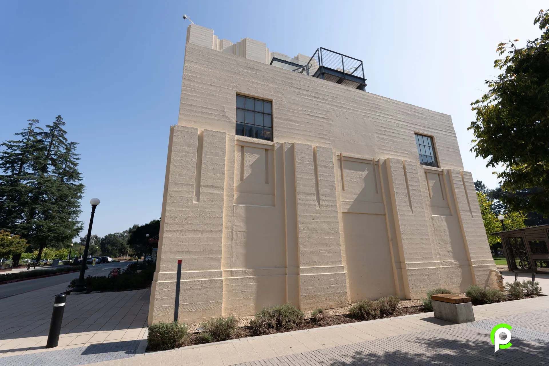 A large white building with a balcony on top of it.
