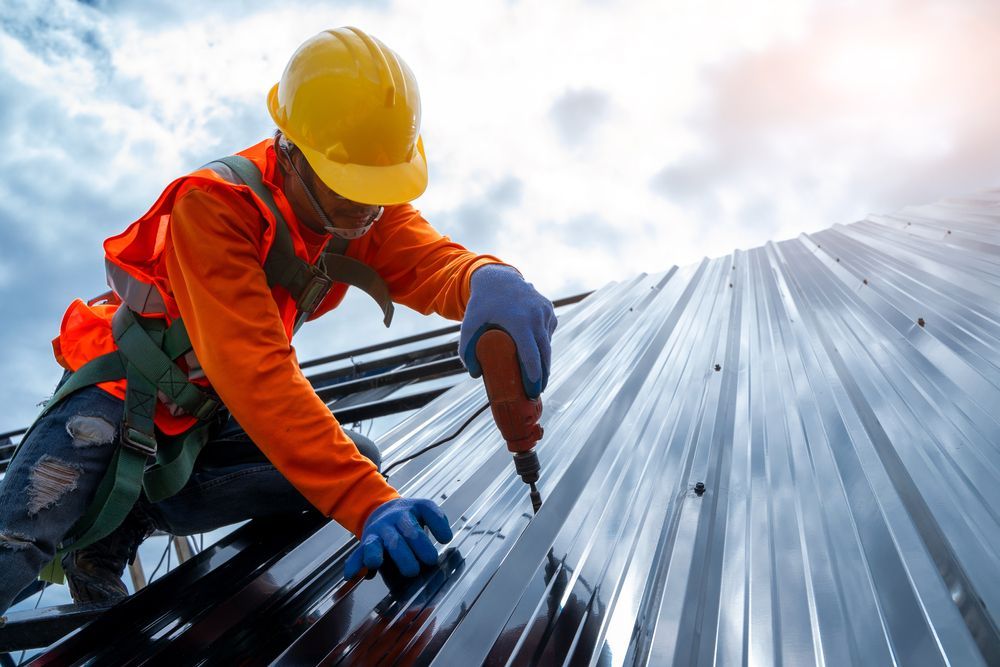 Roofer in A Safety Harness on A Gray Tiled Roof — Newcastle Roofing Wizards In Cessnock, NSW