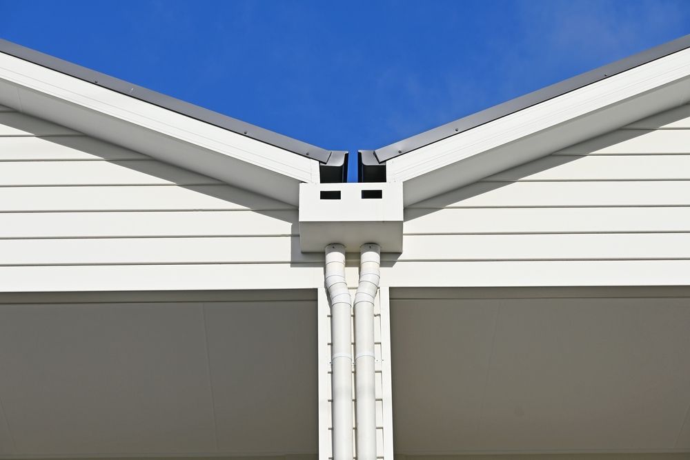 White Rain Gutters and Downspouts on A Building — Newcastle Roofing Wizards In Tingira Heights, NSW