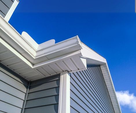 The roof of a house with a blue sky in the background