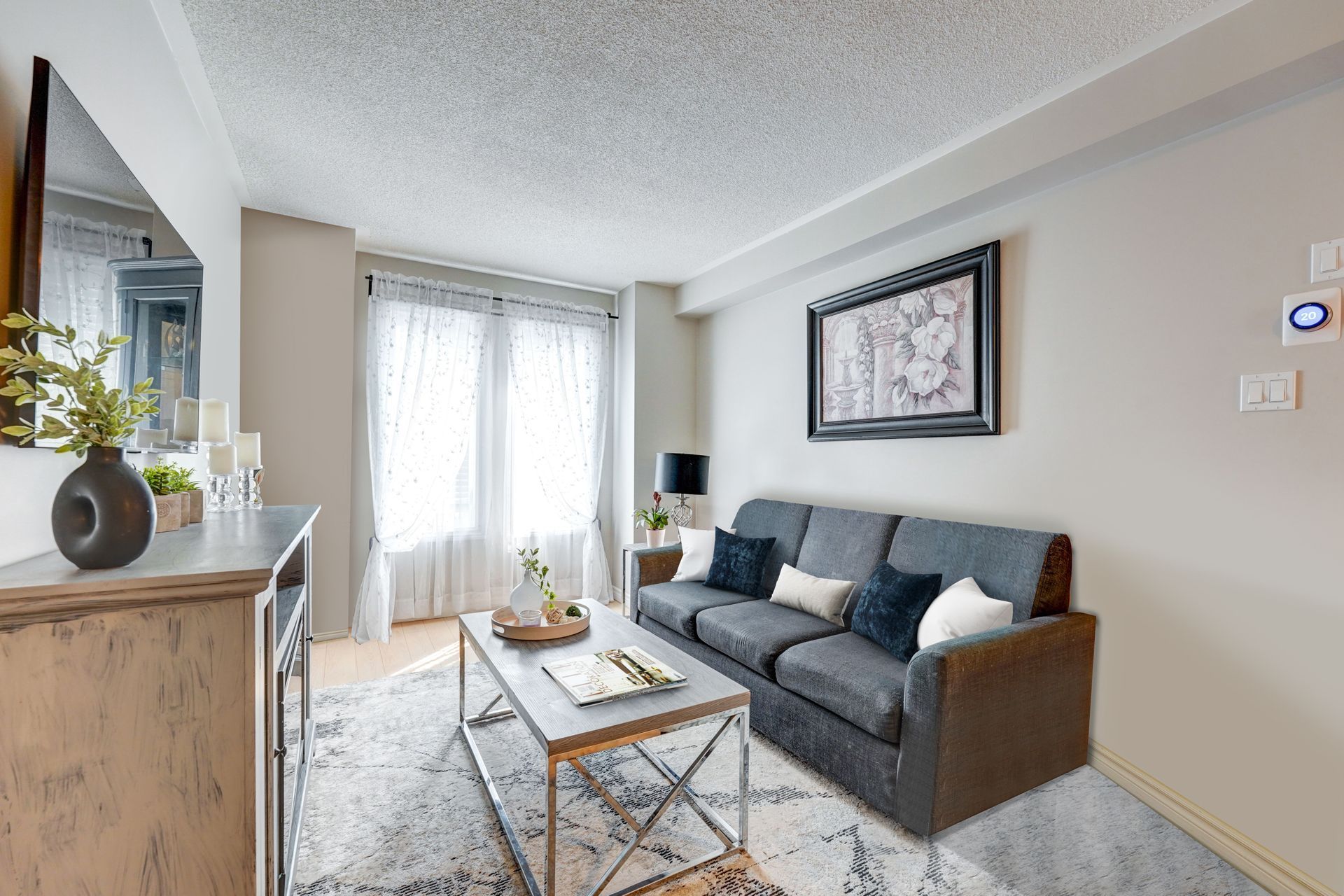 A living room with a couch , coffee table , and television.