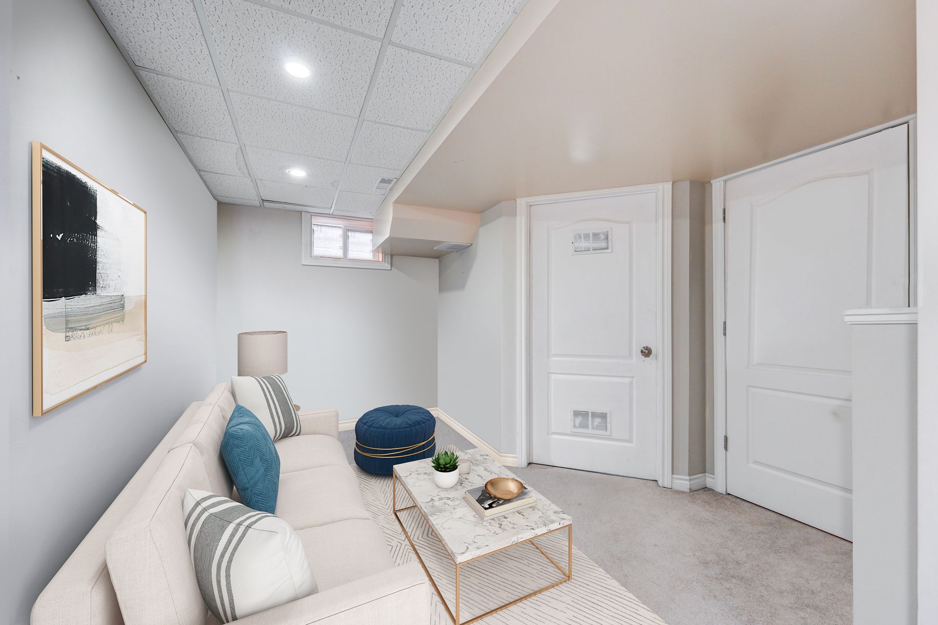 A living room with a couch and a coffee table in a basement.
