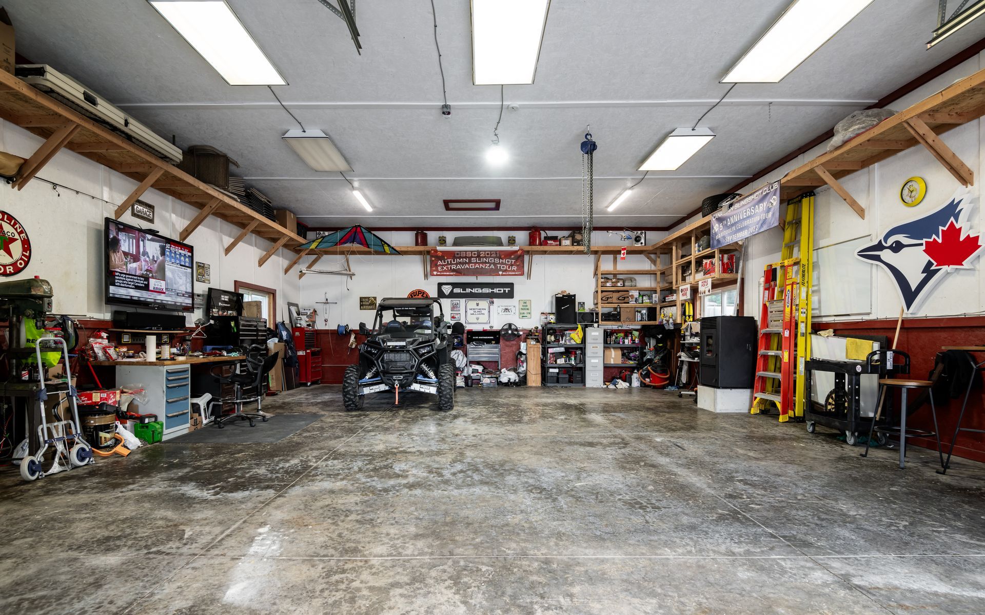 There is a blue jays flag on the wall of the garage.