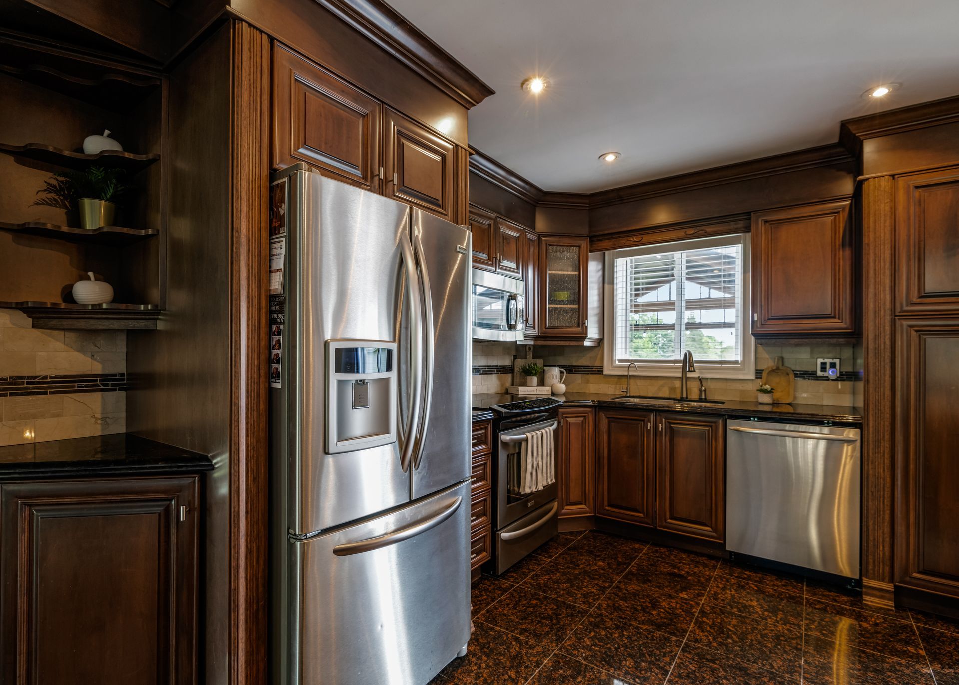 A kitchen with stainless steel appliances and wooden cabinets.