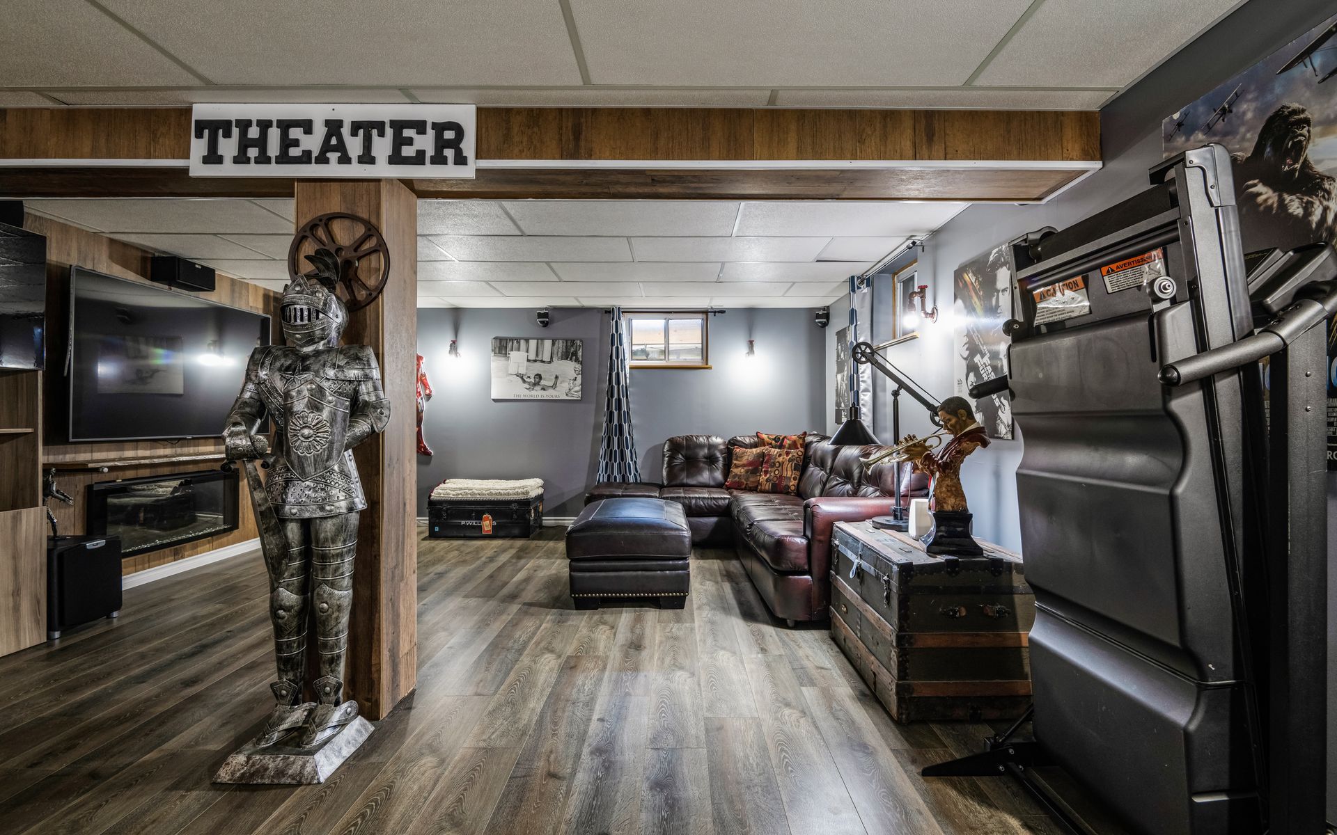 A living room with a statue of a knight and a sign that says theater.