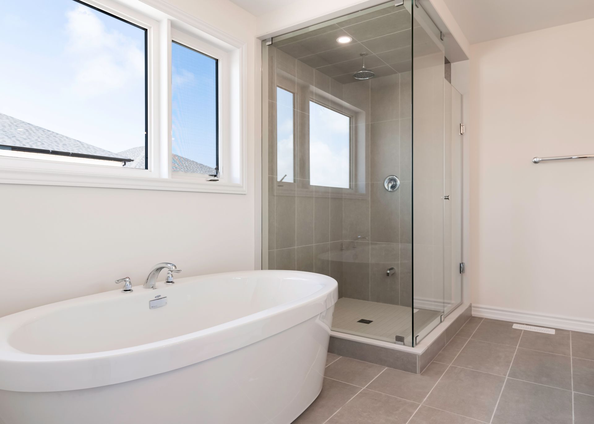 A bathroom with a bathtub and a walk in shower