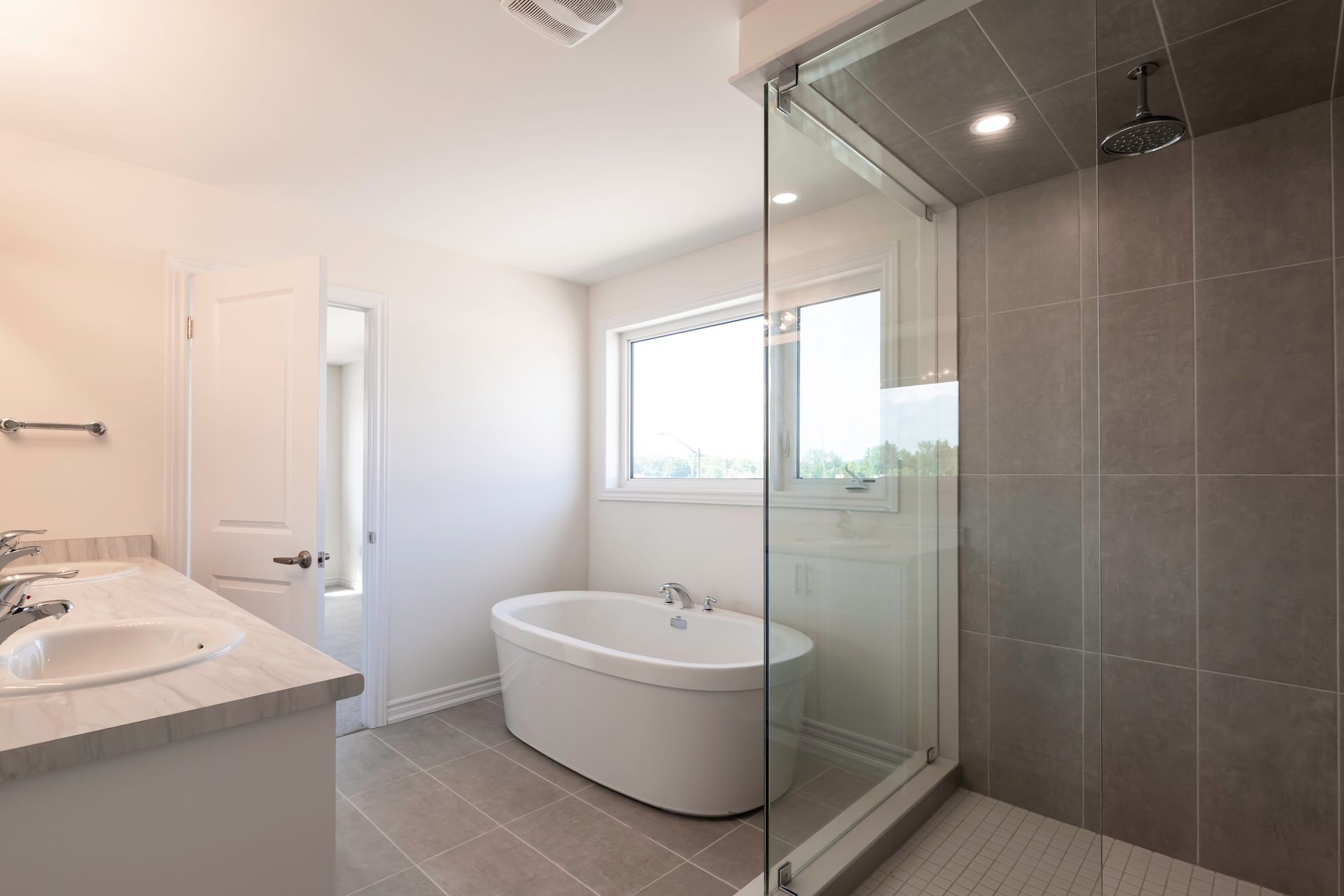 A bathroom with a bathtub and a walk in shower.