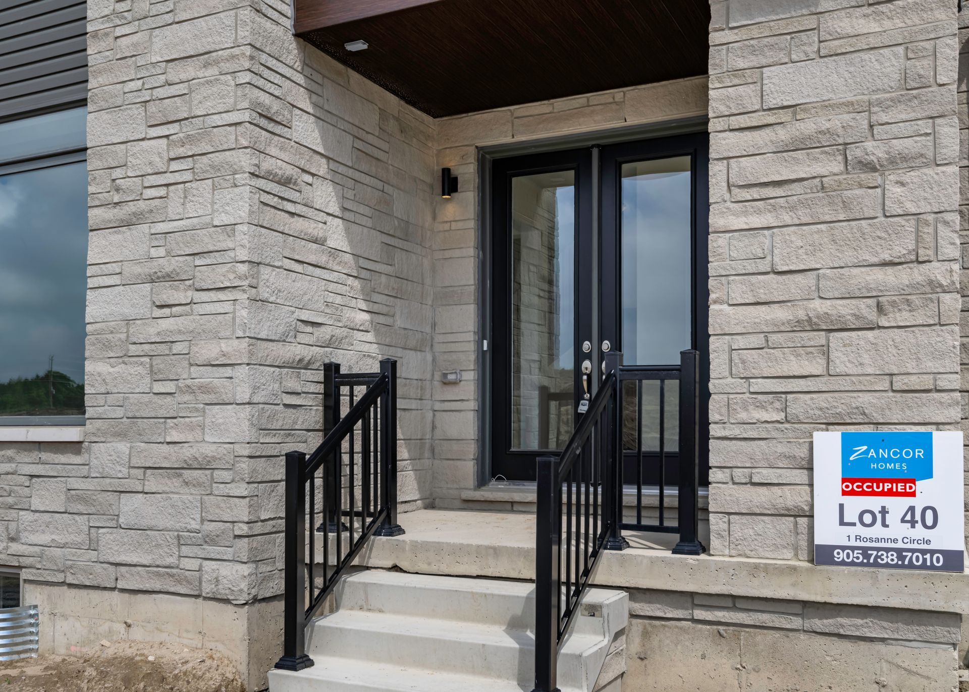 A brick building with stairs and a sign that says lot 40