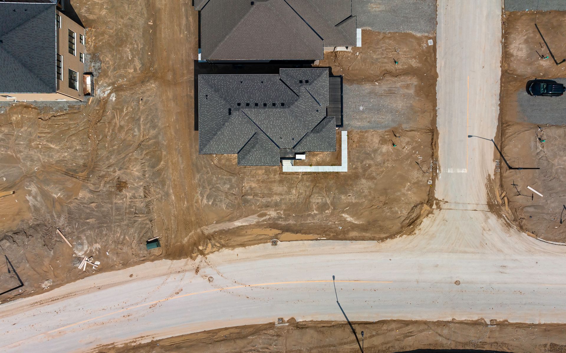 An aerial view of a house under construction in a residential area.