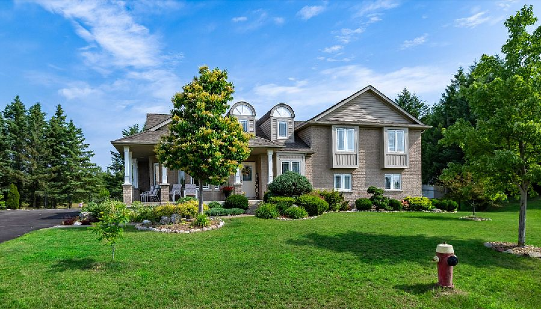 A large house with a fire hydrant in front of it.