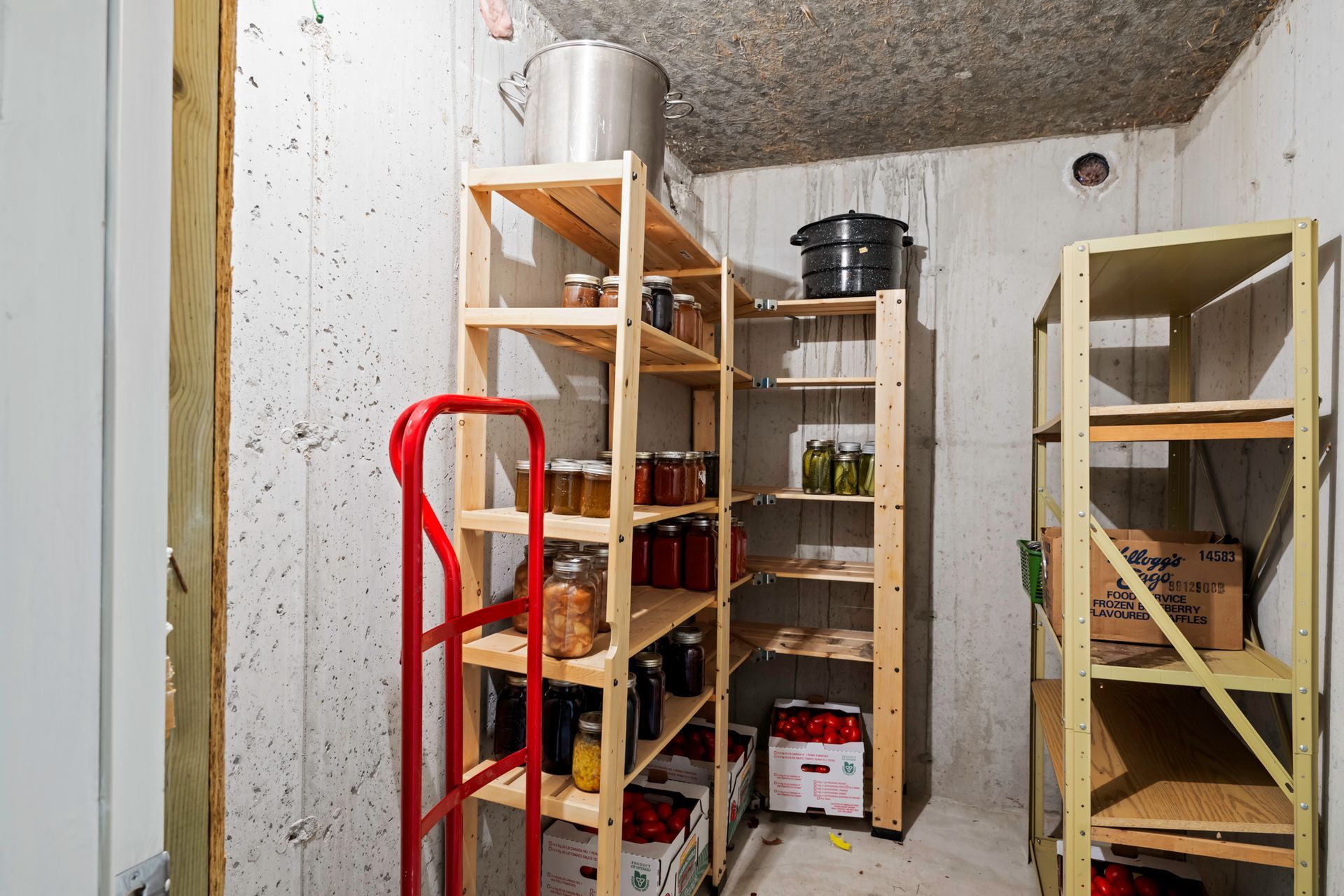 A room with wooden shelves filled with jars and boxes.