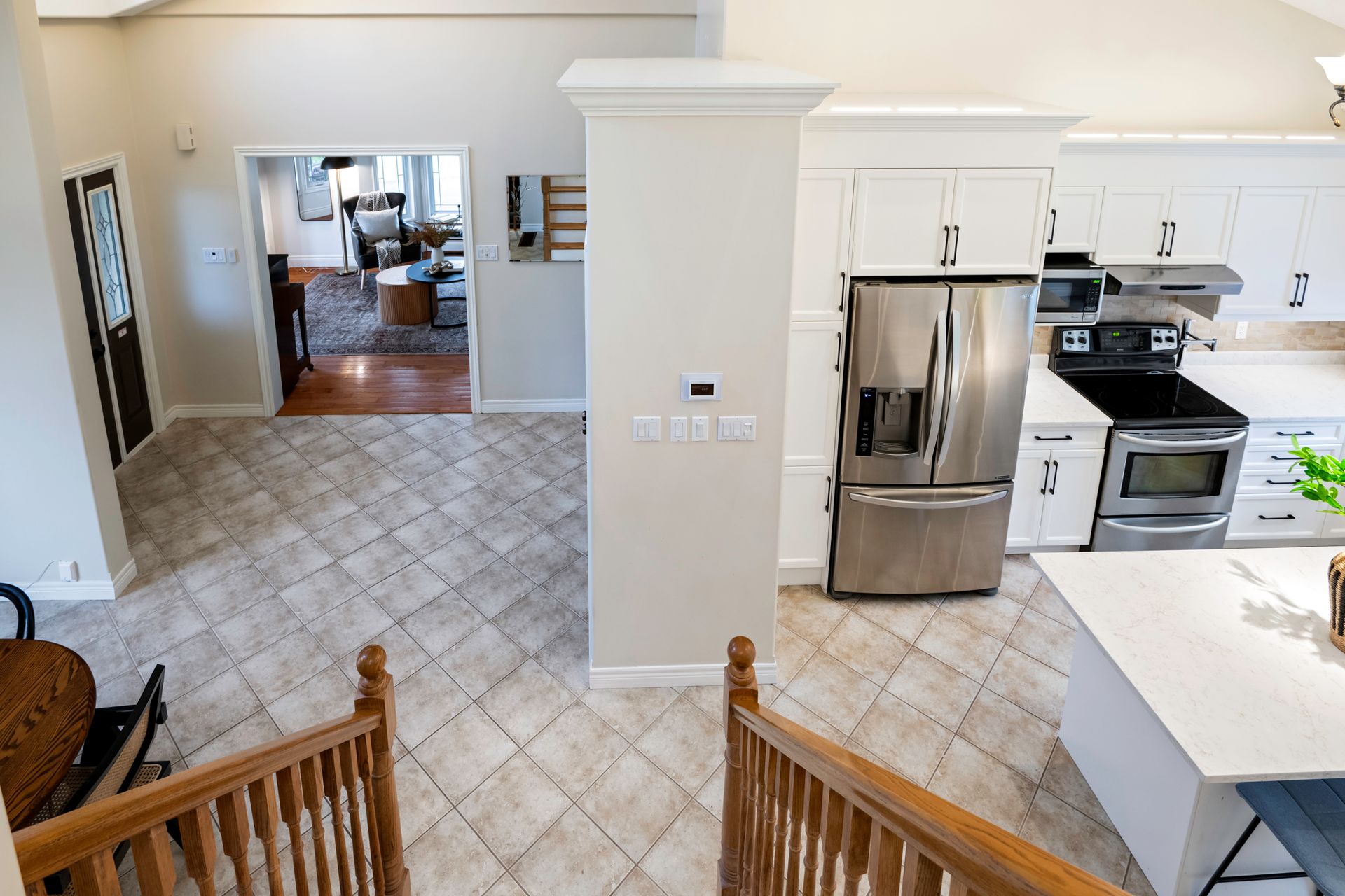 An aerial view of a kitchen with stainless steel appliances and white cabinets.