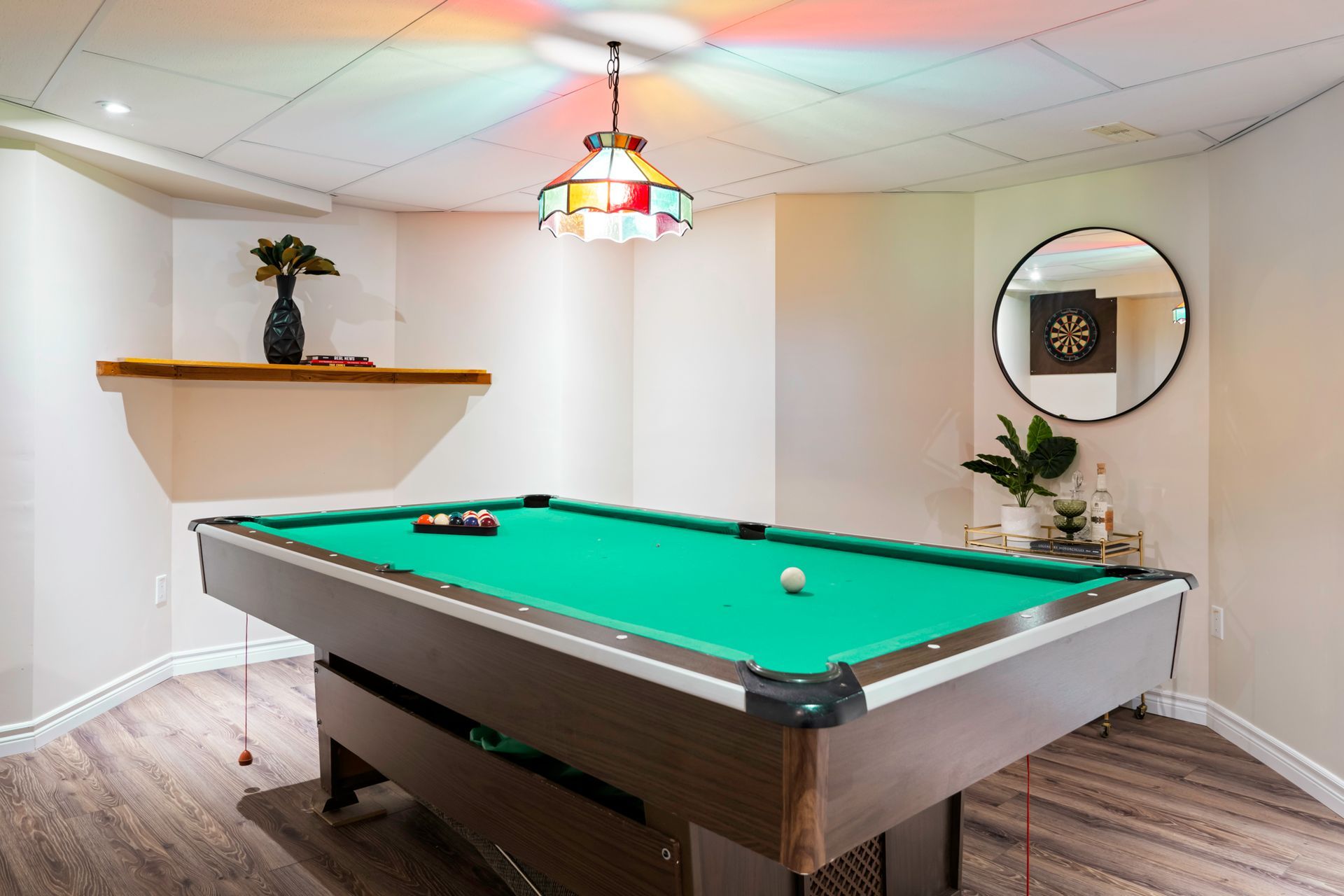 There is a pool table in the middle of the room.