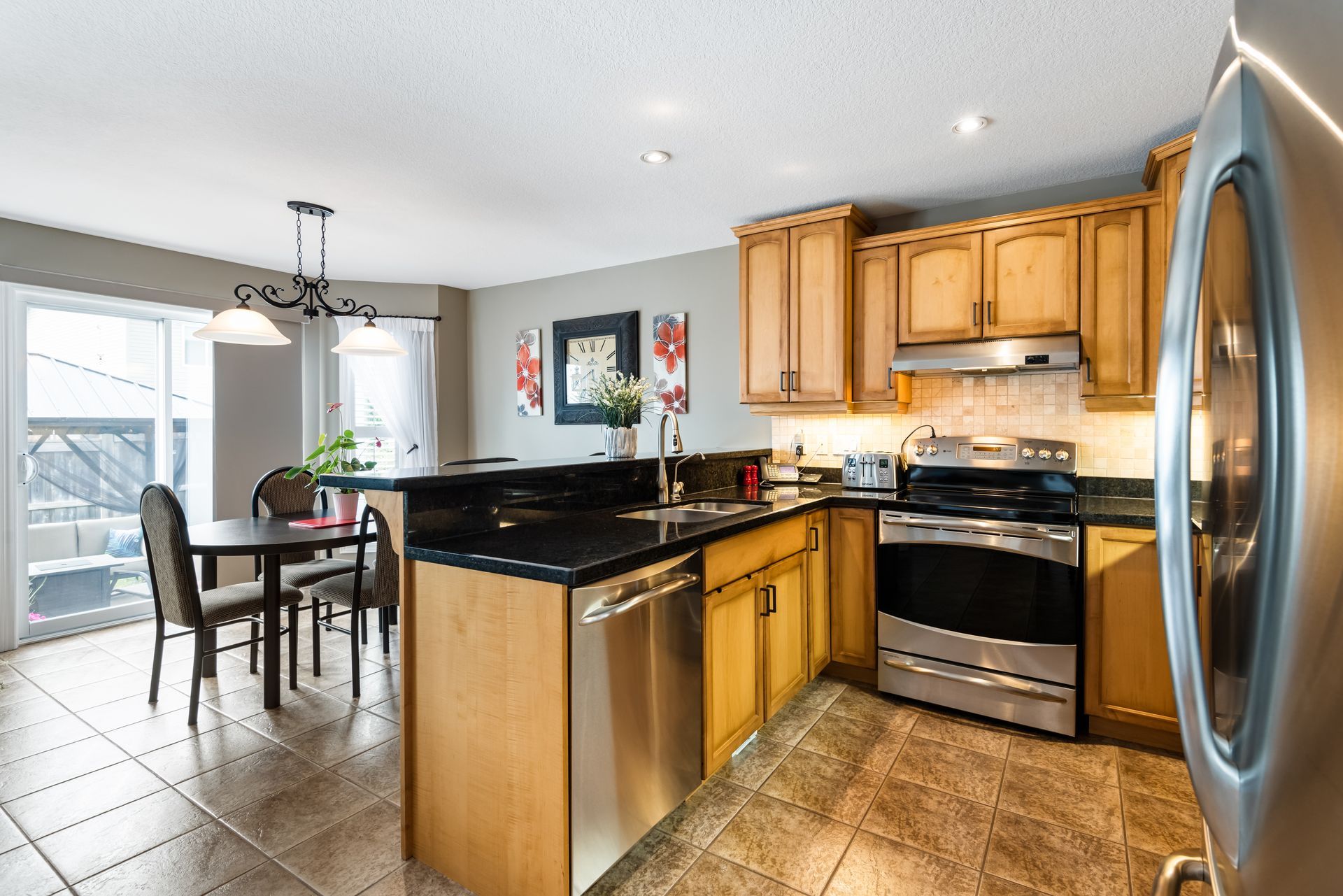A kitchen with stainless steel appliances and wooden cabinets