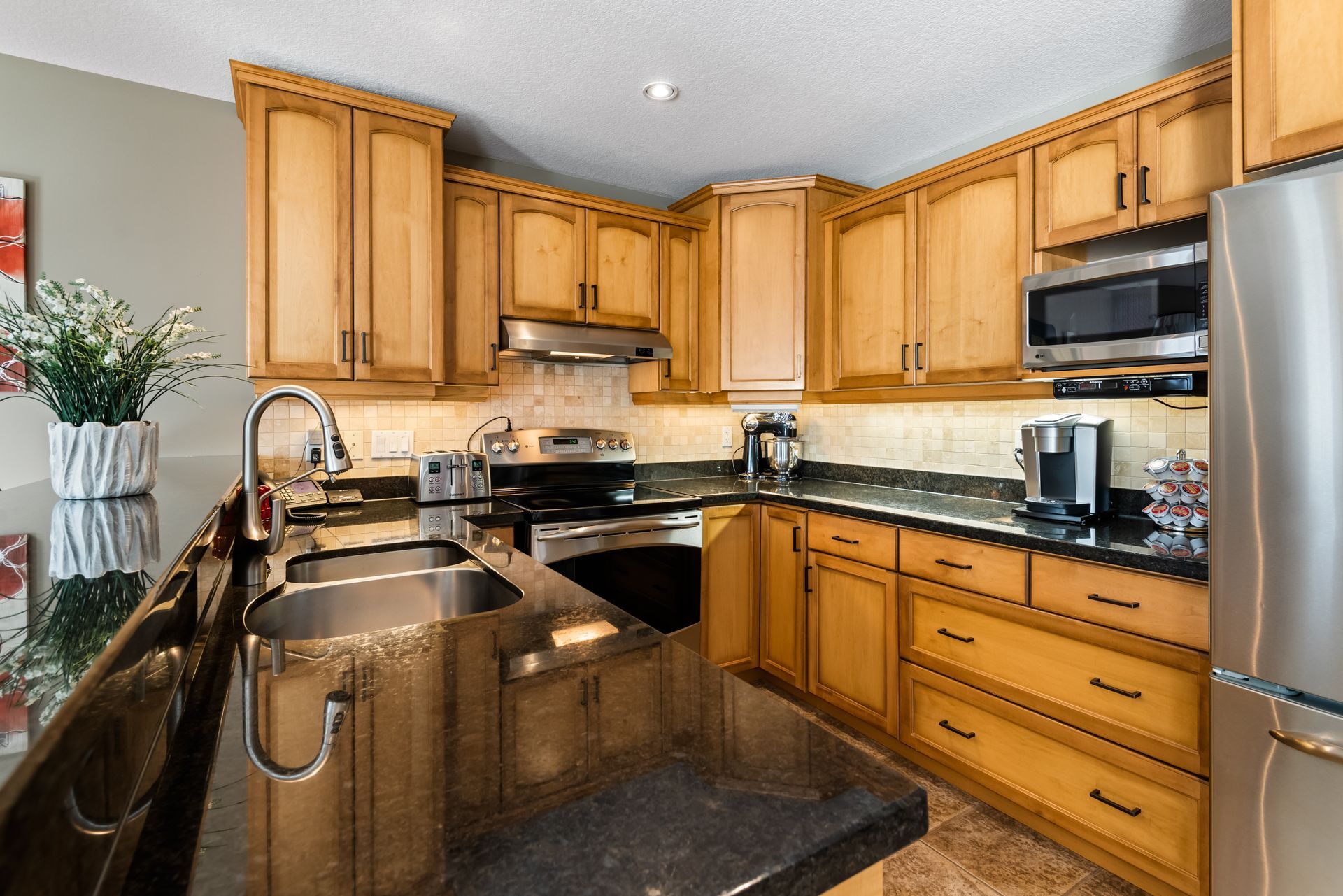 A kitchen with stainless steel appliances and wooden cabinets