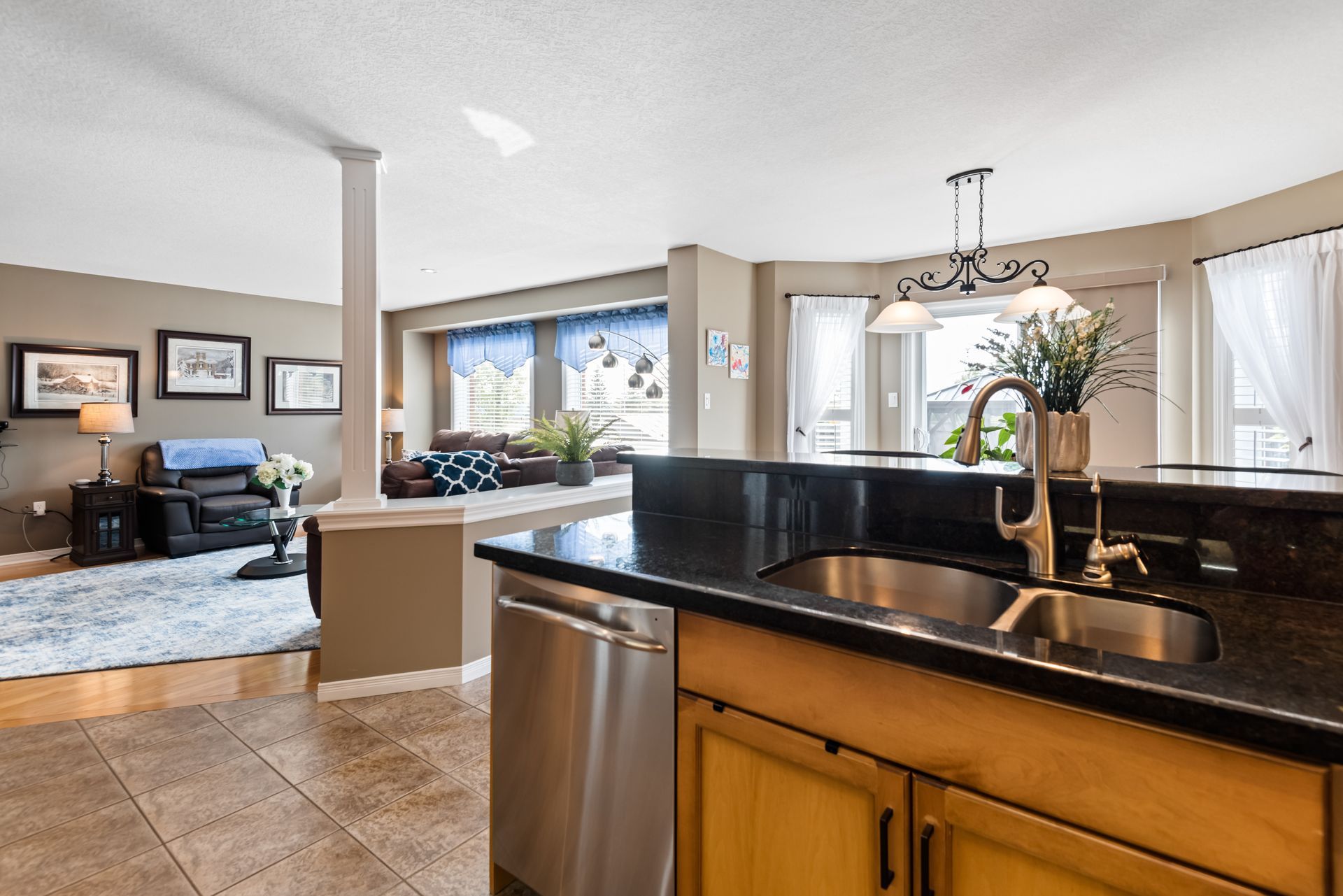 A kitchen with a sink and stainless steel appliances