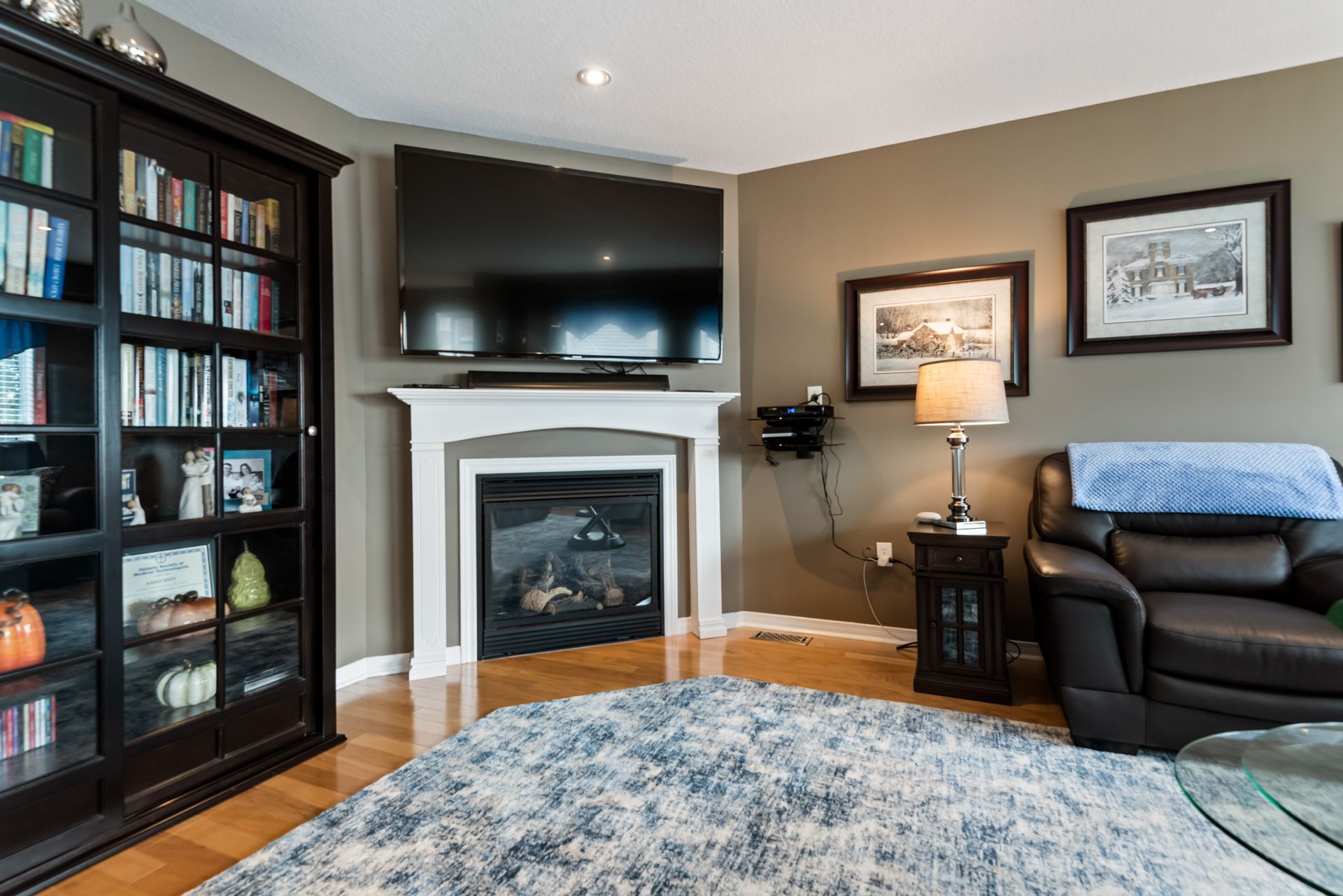 A living room with a fireplace and a flat screen tv.
