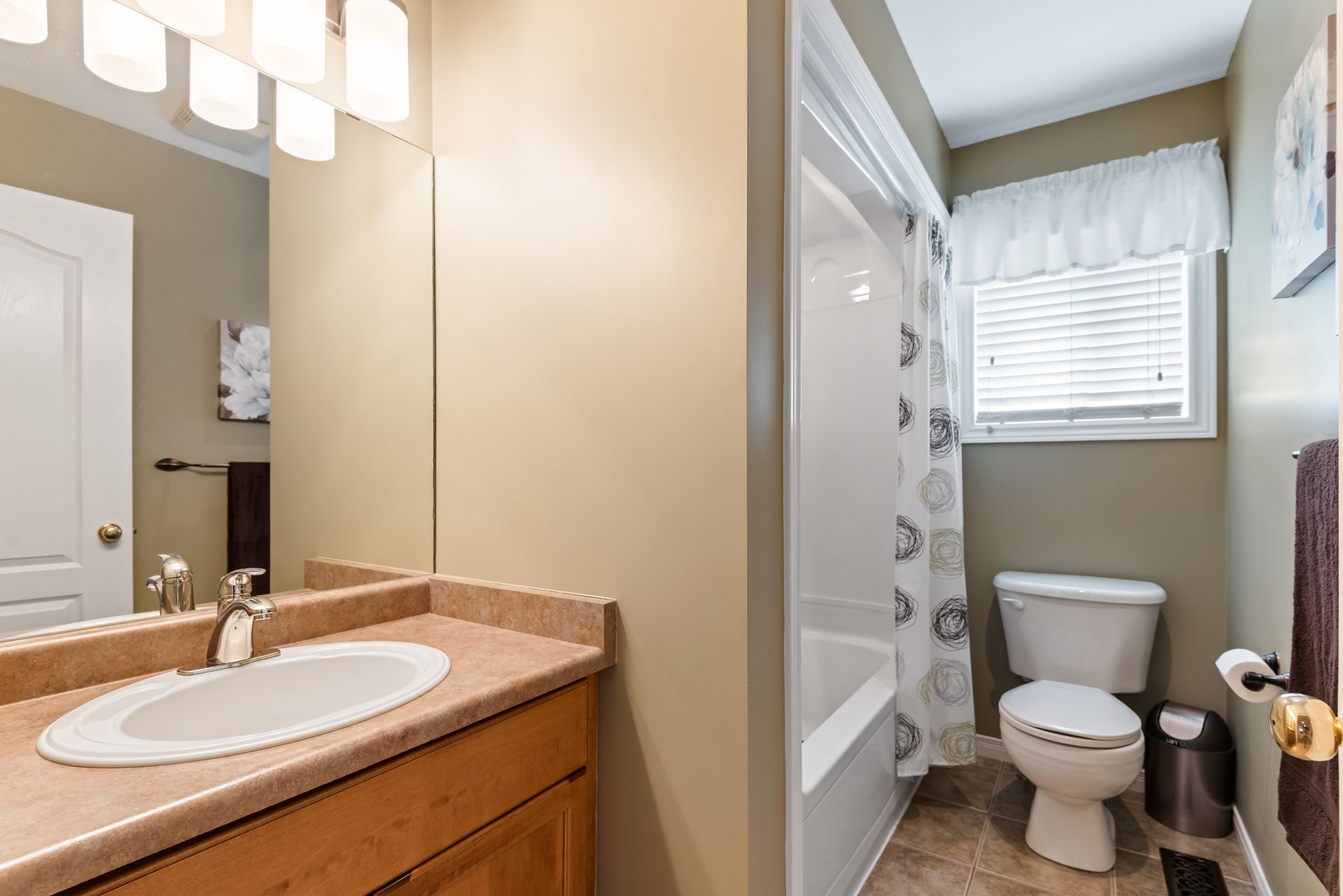 A bathroom with a sink , toilet , and shower.