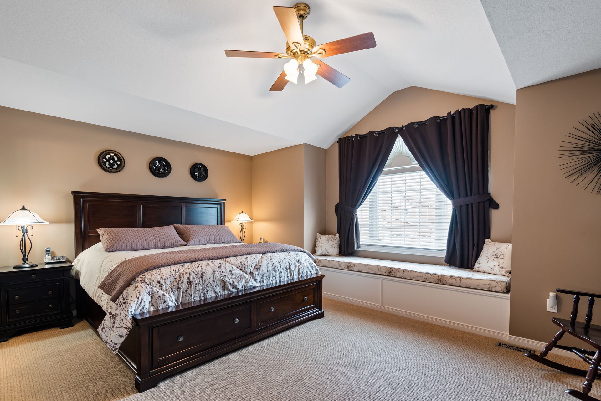 A bedroom with a large bed and a window seat