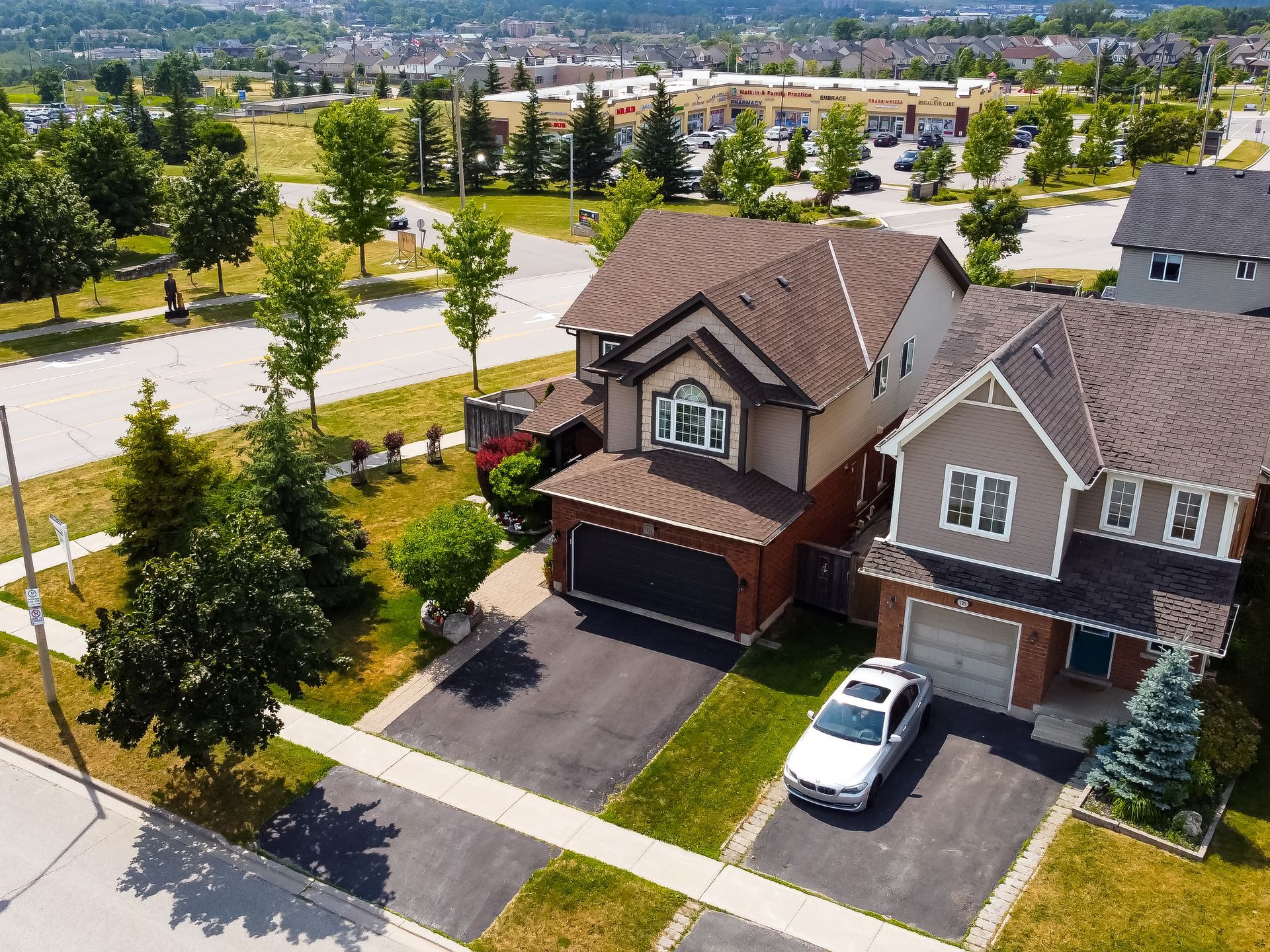 An aerial view of a house with a car parked in front of it
