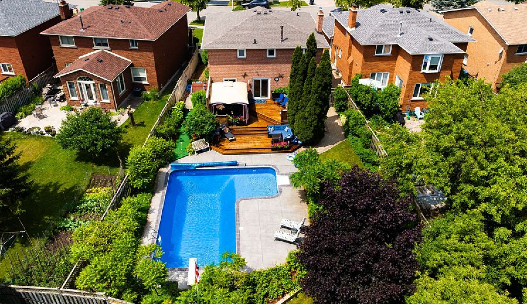 A brick house with a garage and a driveway in front of it.