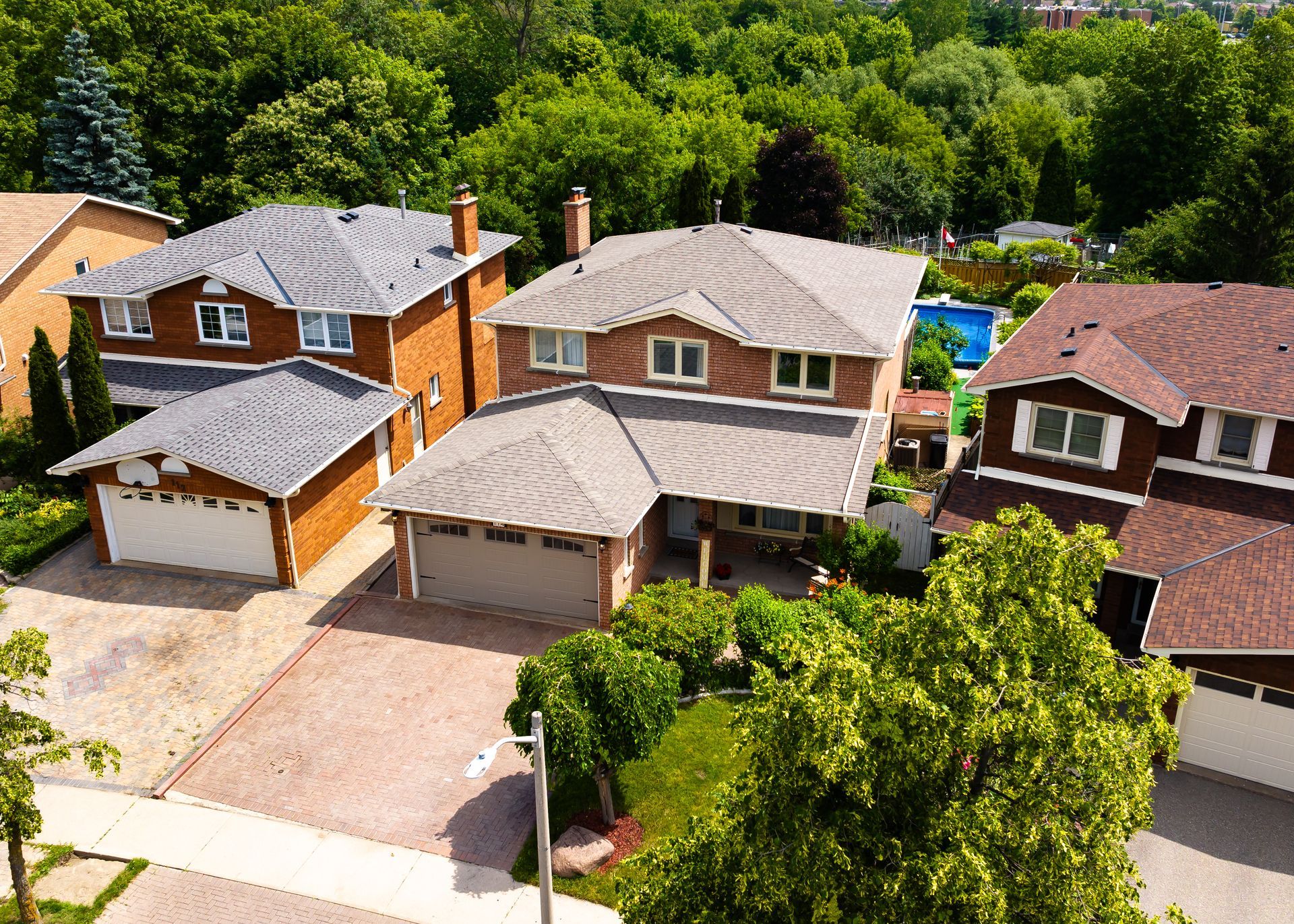an aerial view of a residential area with houses and trees