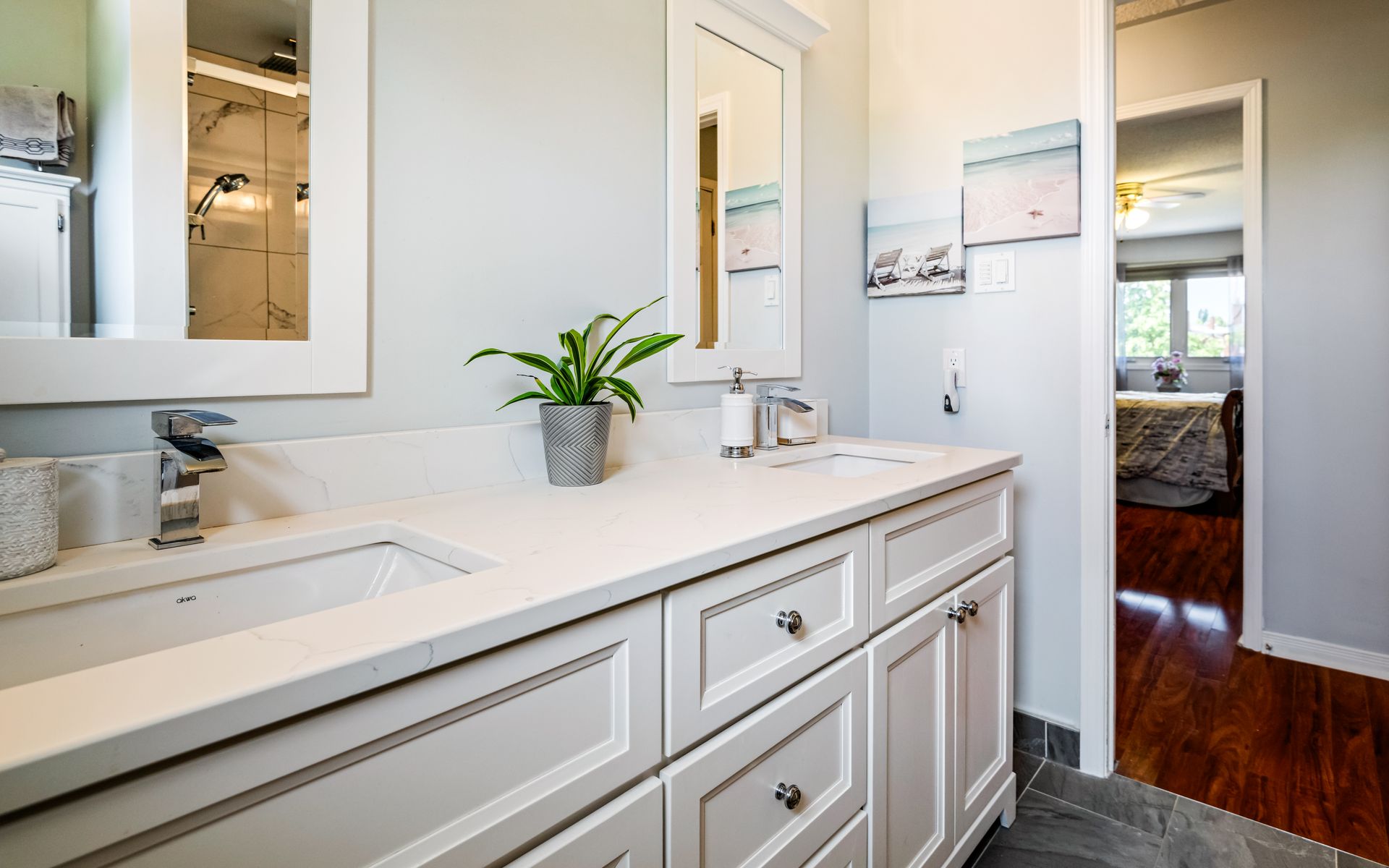 A bathroom with a sink , mirror , and cabinets.