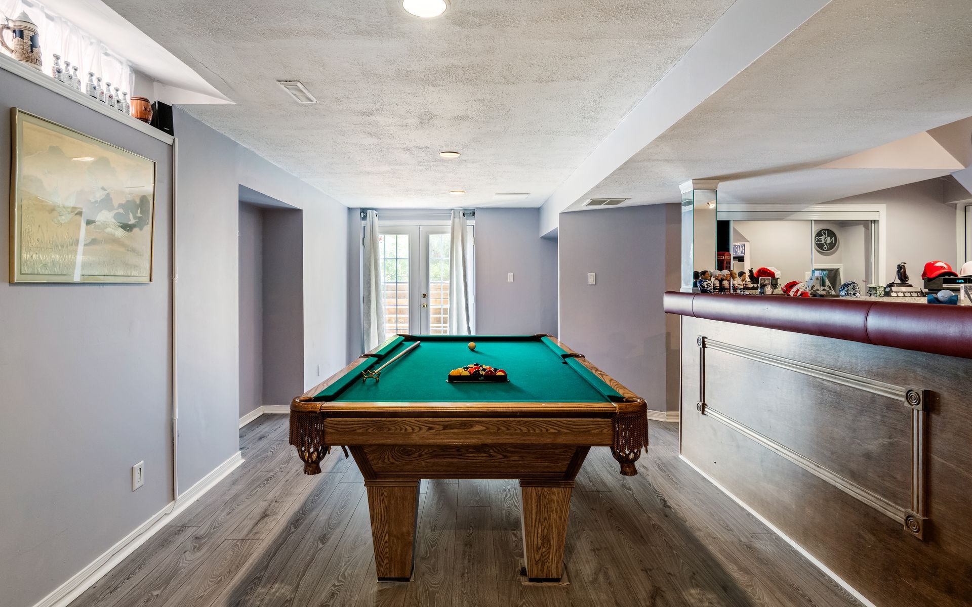 There is a pool table in the middle of the room.