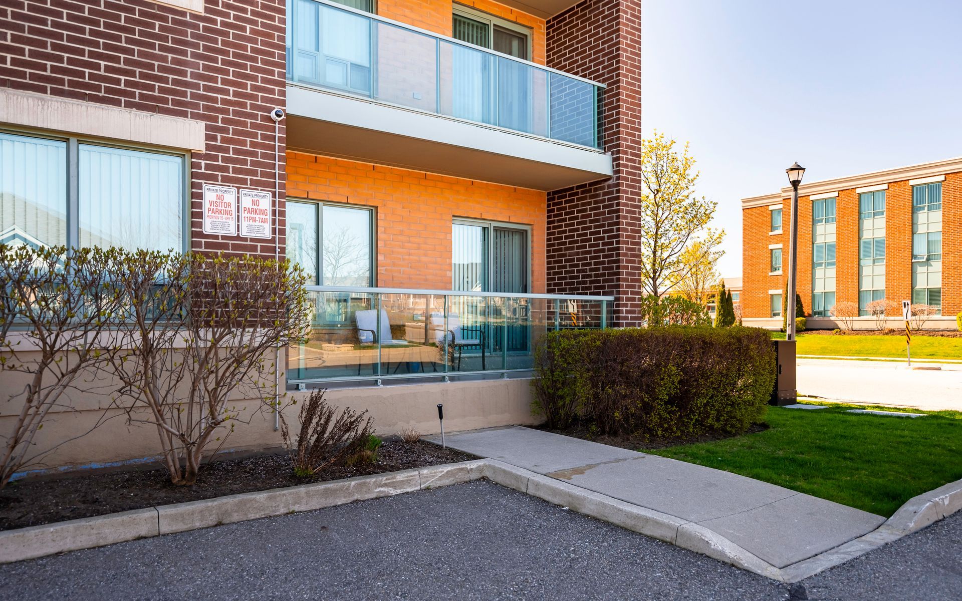 A brick building with a balcony and a ramp leading to it.