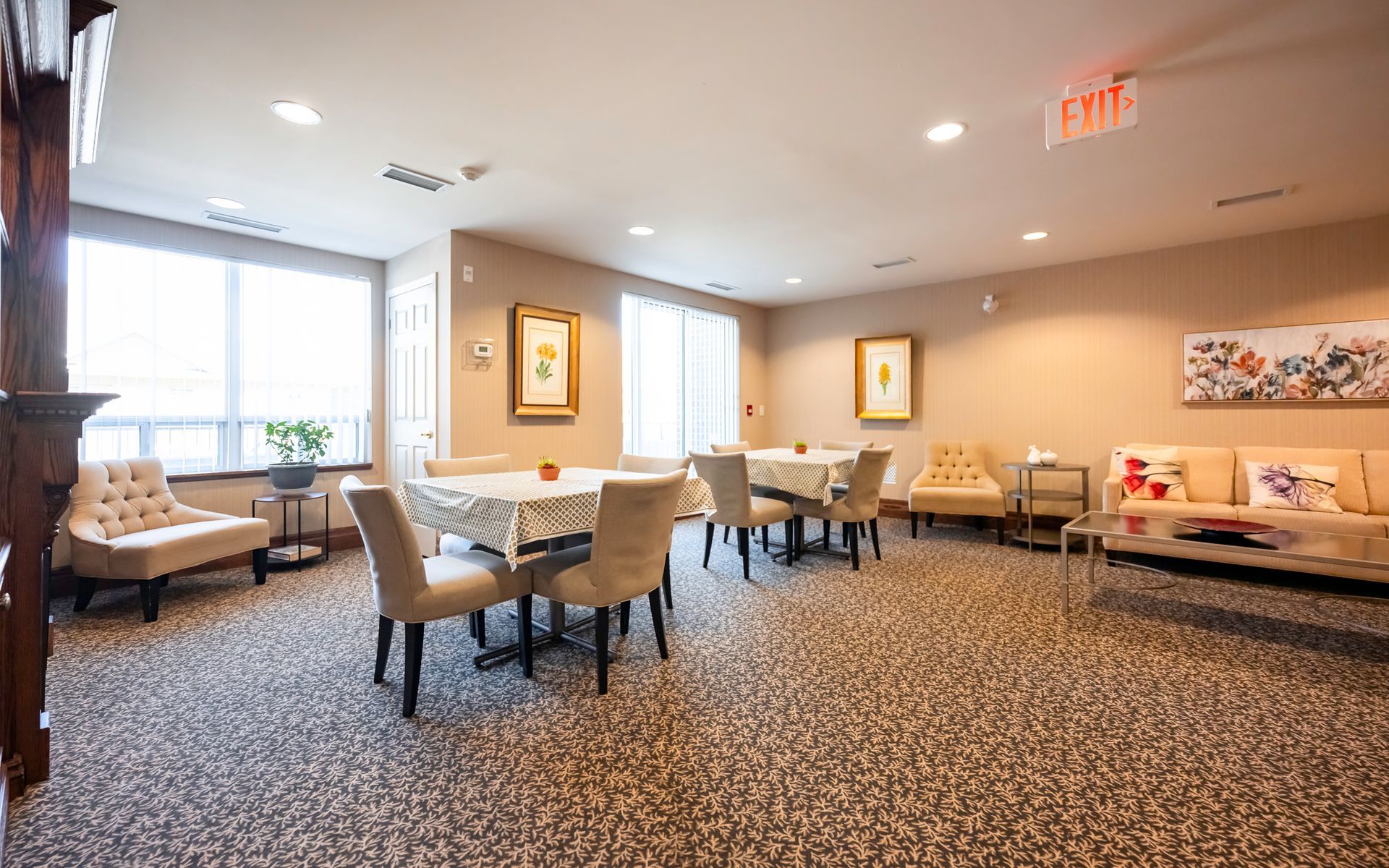 A large room with tables and chairs and a couch.
