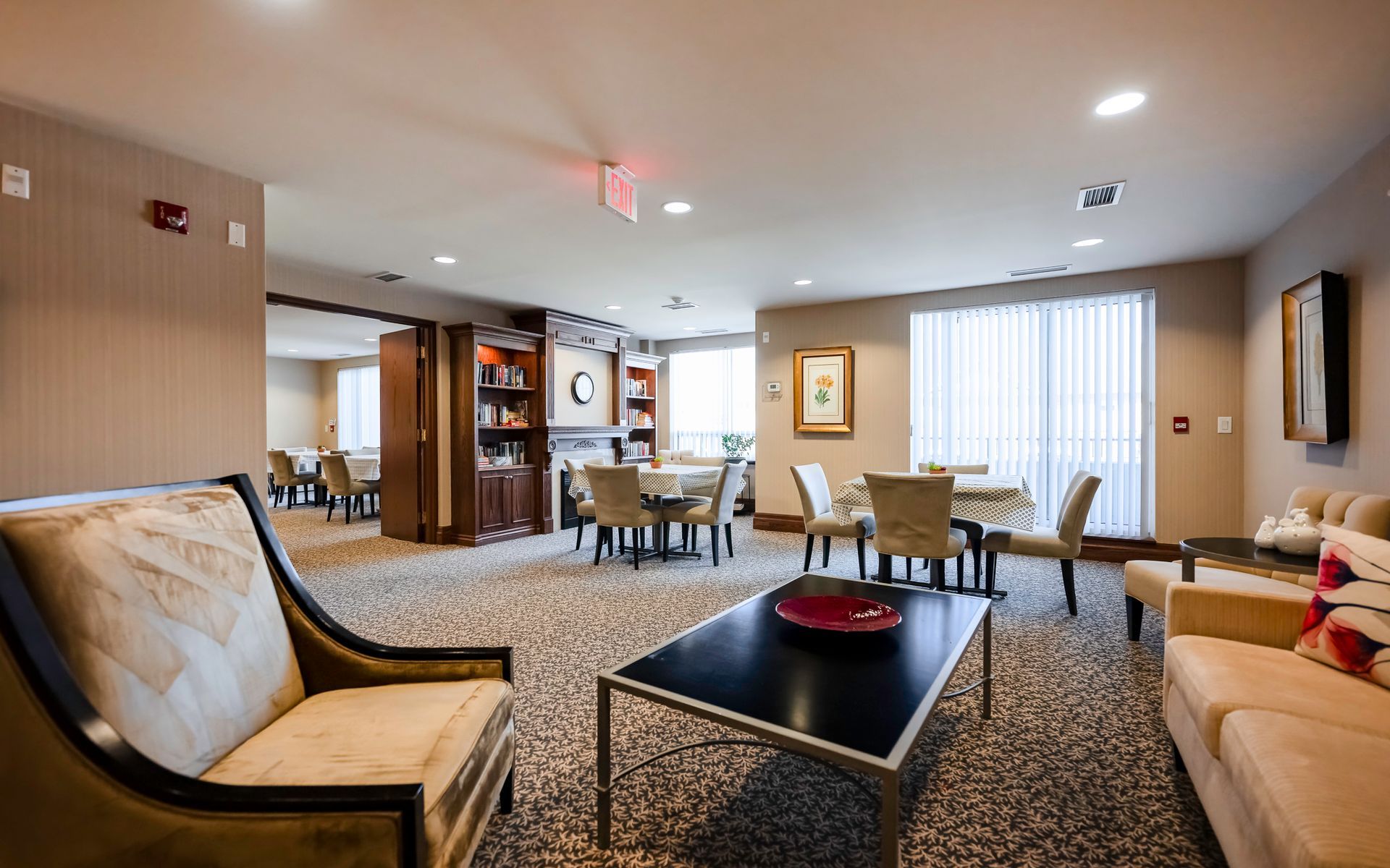 A living room with a couch , chair , coffee table and tables.