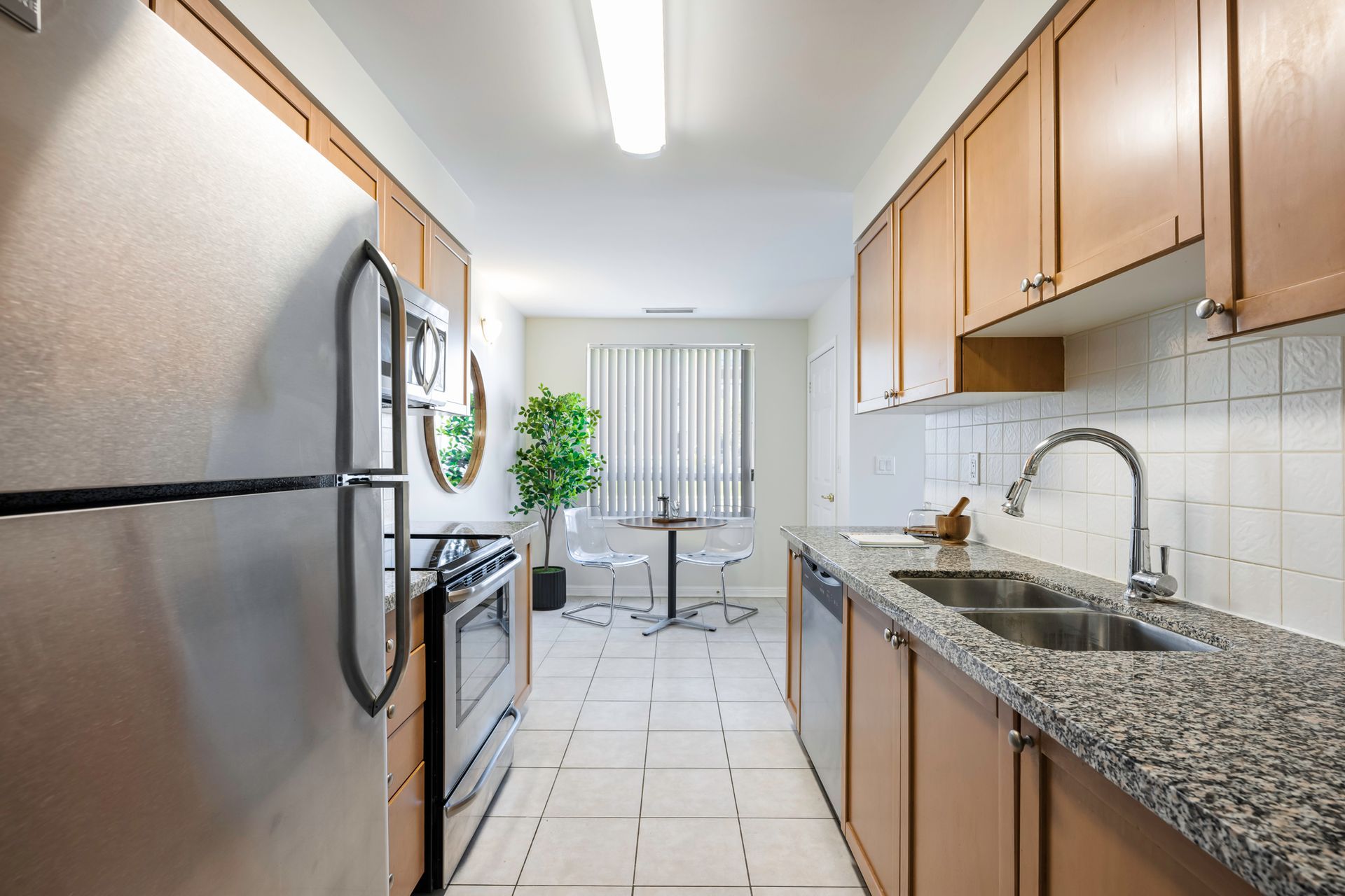 A kitchen with stainless steel appliances and granite counter tops