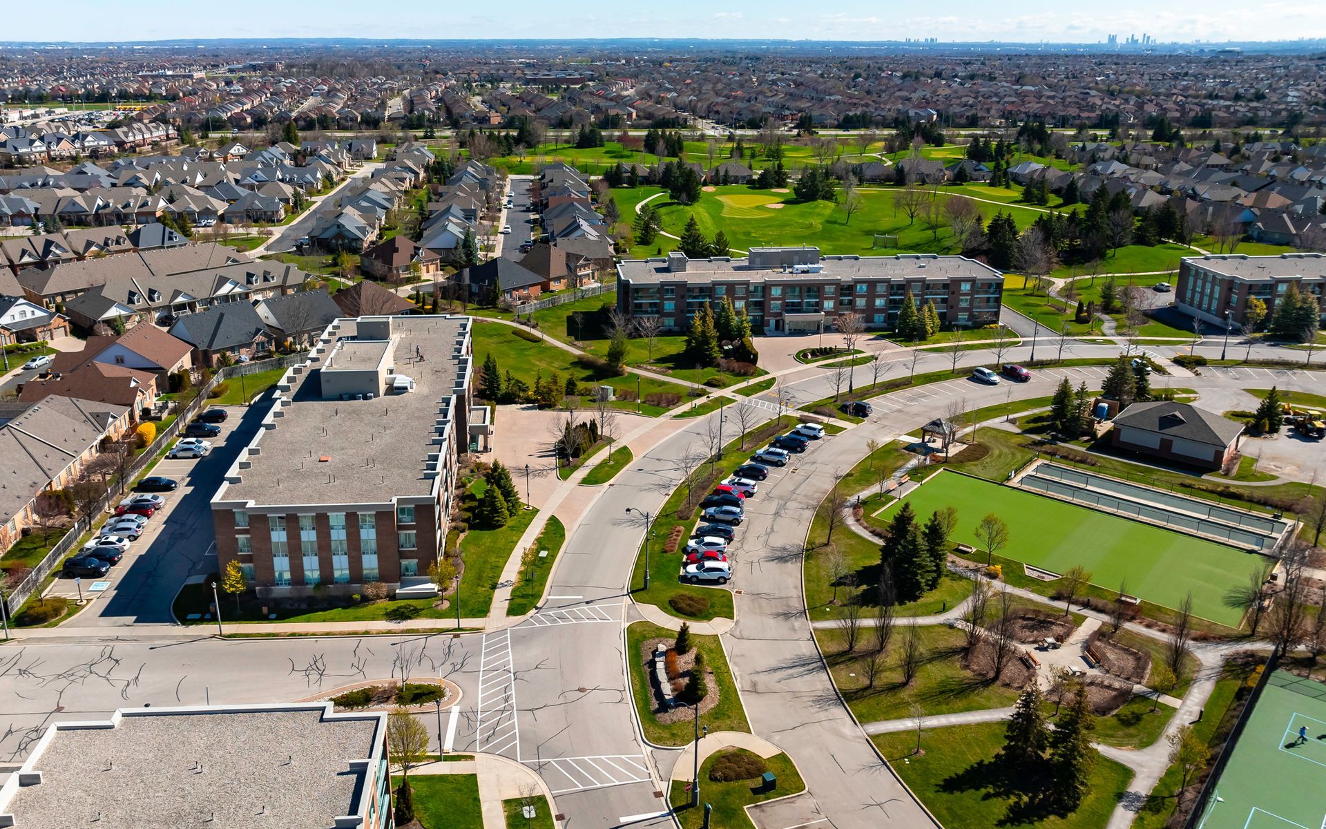 An aerial view of a residential area with lots of buildings and a park.