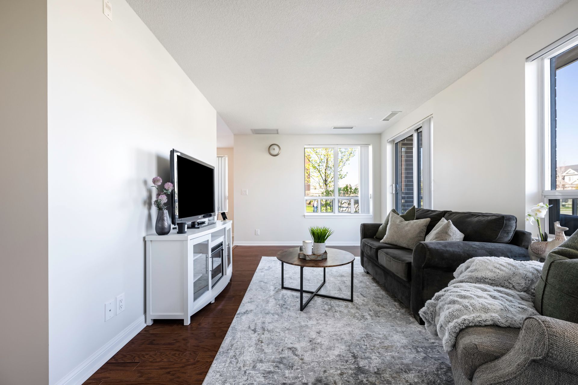 A living room with a couch , table , and television.