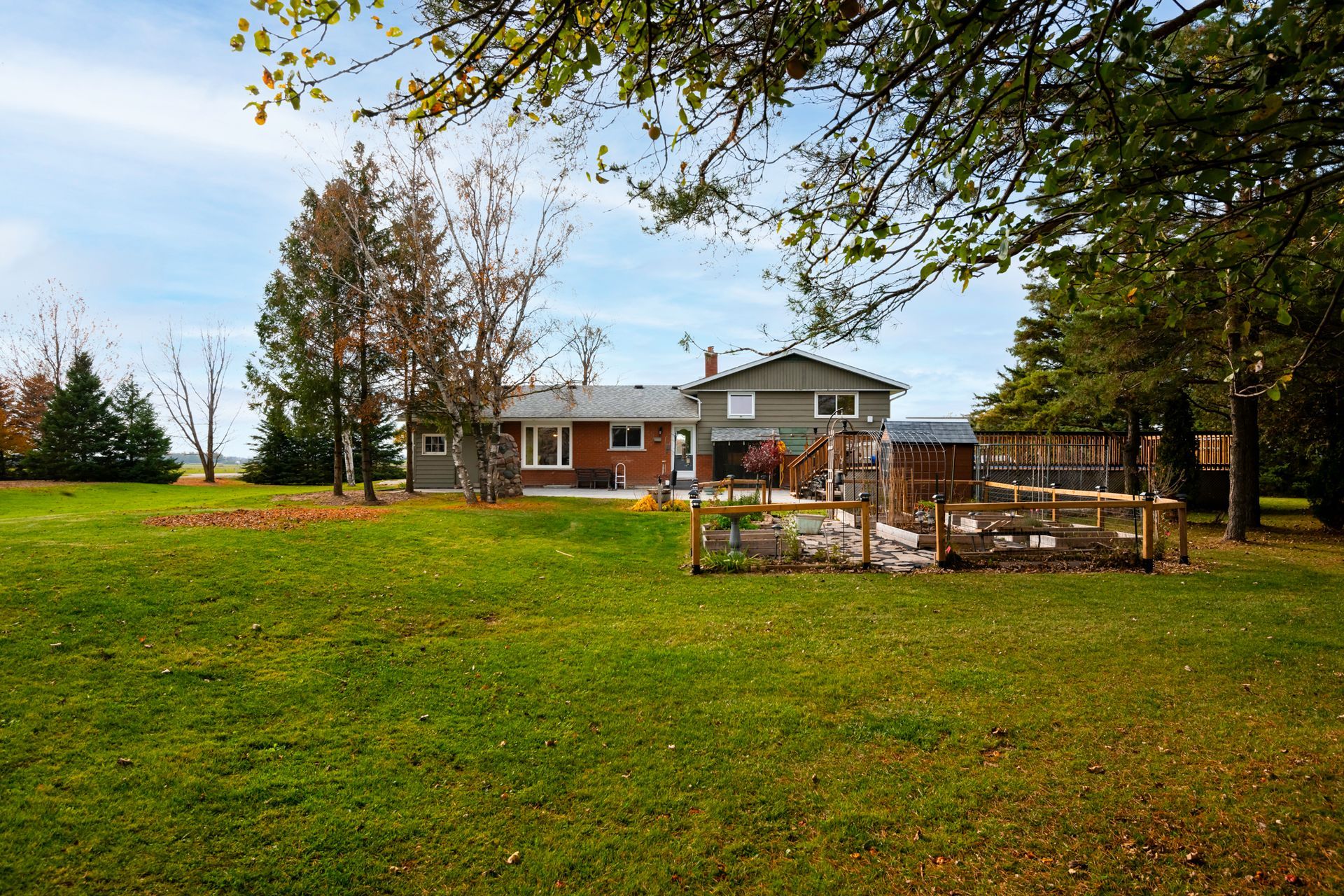 A large grassy field with a house in the background
